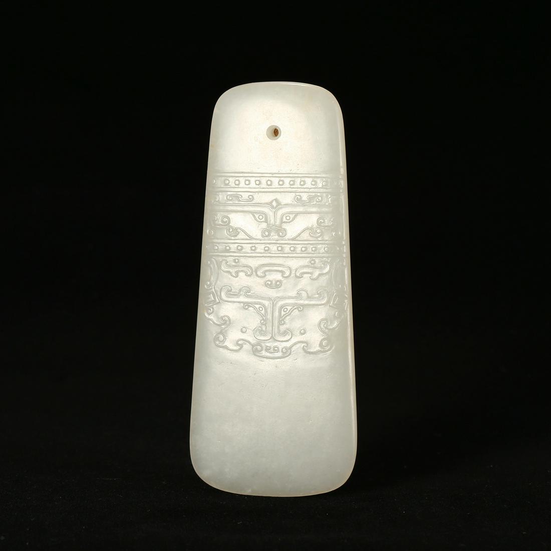 A WHITE JADE 'MYTHICAL BEAST' AXE (1 of 3)