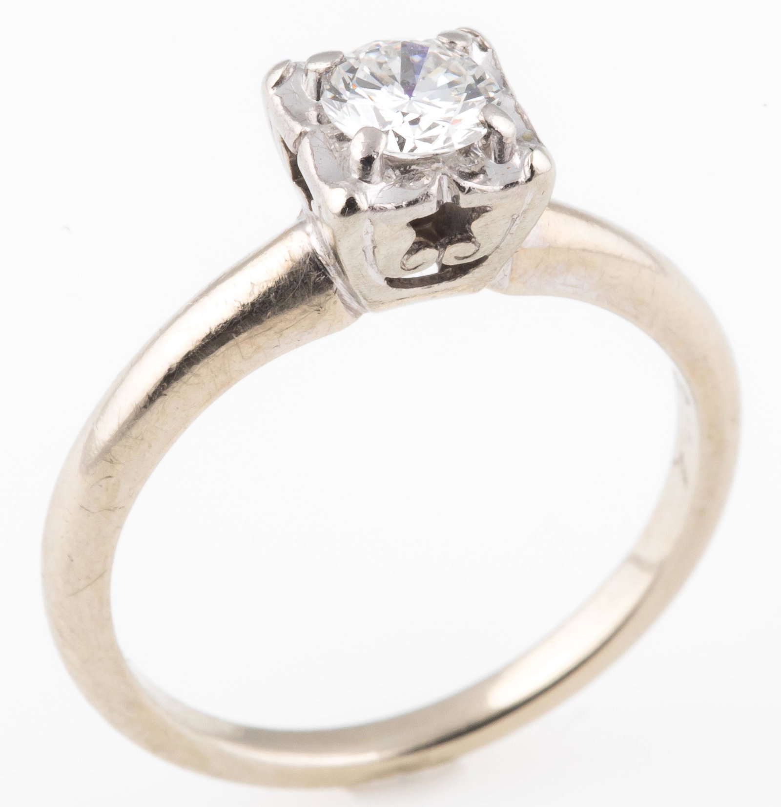 14K WHITE GOLD TRAUB DIAMOND ENGAGEMENT RING: 14K WHITE GOLD TRAUB DIAMOND ENGAGEMENT RING 14K white gold solitaire engagement ring with round cut diamond of approximately 0.3 Ct, set in openwork gallery. Marked "Orange Blossom" by Traub Manufact
