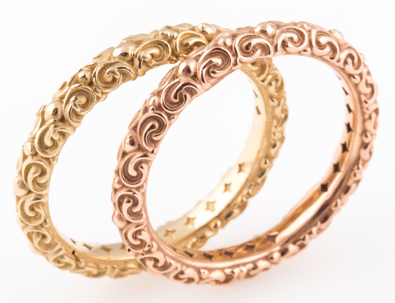 14K YELLOW & ROSE GOLD SCROLL PATTERN BANDS LOT OF 2: 14K YELLOW & ROSE GOLD SCROLL PATTERN BANDS LOT OF 2 Two matching 14K yellow and rose gold stacking or wedding band rings with scrolling pattern. Marked on inside. Size: 6.75 Weight: 7.3 grams