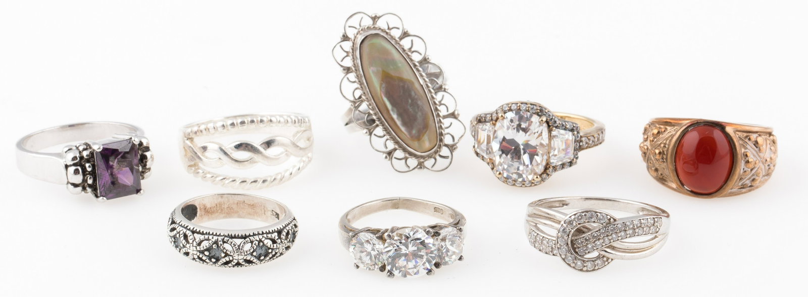 8 STERLING SILVER FASHION RINGS: 8 STERLING SILVER FASHION RINGS Eight sterling silver fashion rings, with stones including: carnelian agate, mother of pearl, amethyst, and cubic zirconia. Size: 4.5 to 8.5 Weight: 35.4 grams