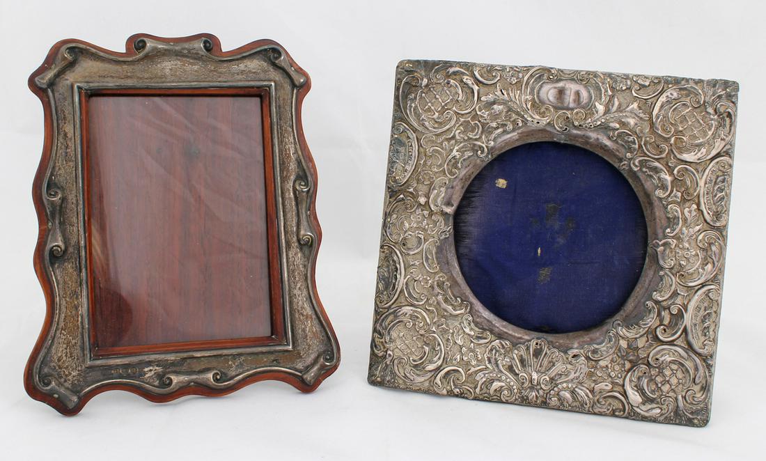 STERLING SILVER PICTURE FRAMES LOT OF TWO: STERLING SILVER PICTURE FRAMES LOT OF TWO Two sterling silver frames with designs including: flowers and ornaments with round frame, approximately 7" tall. Photo size: 4.5 x 4.25". scroll with square
