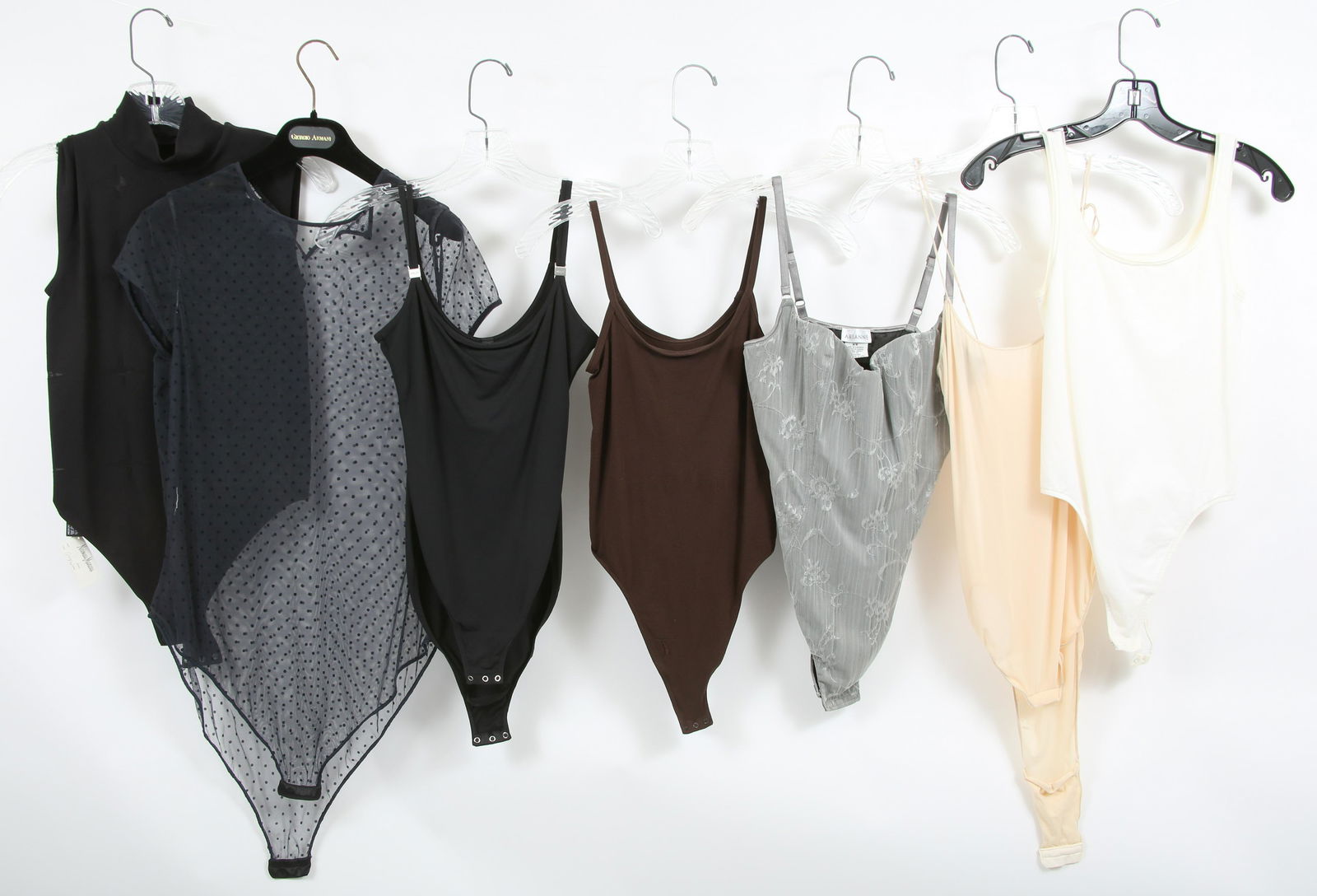 WOMEN'S DESIGNER STRAPPY BODY SUITS - LOT OF 7: WOMEN'S DESIGNER STRAPPY BODY SUITS - LOT OF 7 Neiman Marcus bottom snap body suit with mock turtle neck and mesh "star" designs throughout; very good condition except missing size and material tags