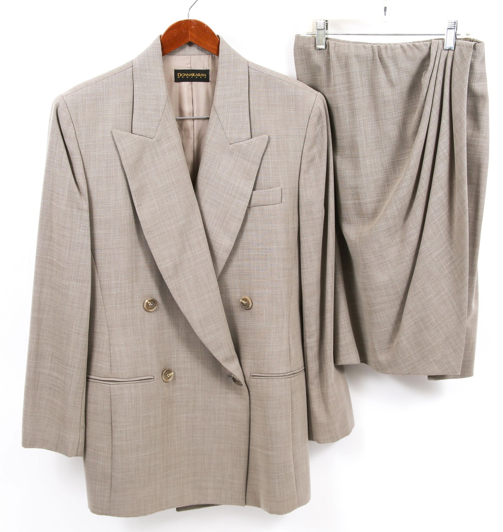 WOMEN'S DKNY TAN SKIRT SUIT: WOMEN'S DKNY TAN SKIRT SUIT Women's DKNY tan skirt suit with blazer and matching skirt, includes: Size 10 blazer; neck to hemline 32.5"; 18.5" shoulder to shoulder; 24" sleeve length; 100% wool. Size