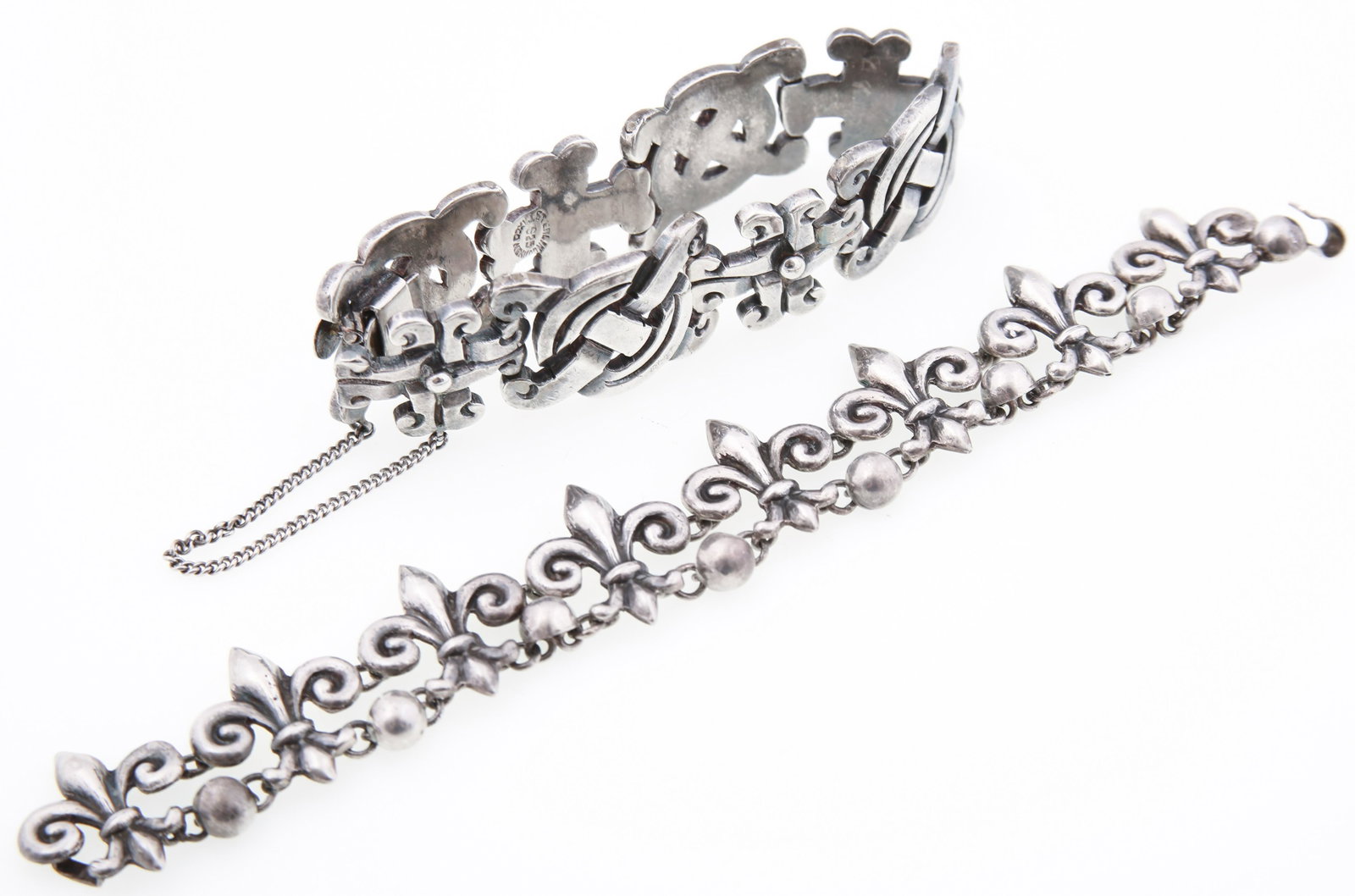 STERLING SILVER TAXCO BRACELETS - LOT OF 2: STERLING SILVER TAXCO BRACELETS - LOT OF 2 Two sterling silver Taxco bracelets, includes: Fleur-de-lis pattern, 7.25", signed Lopez, 980 silver Mayan pattern, 7.25" with safety chain, 925 silver