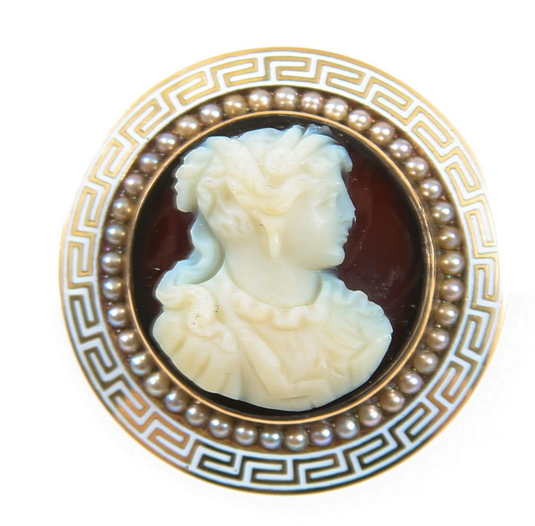 14K YELLOW GOLD ONYX & SHELL CAMEO BROOCH PENDANT: 14K YELLOW GOLD ONYX & SHELL CAMEO BROOCH PENDANT 14K yellow gold and enamel brooch pendant with an onyx and shell cameo surrounded by seed pearls. Size: 28.3mm diameter Weight: 9.1g
