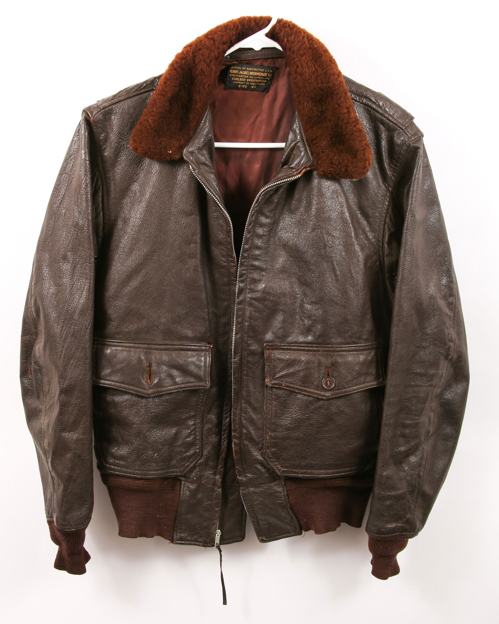 USN G-1 LEATHER PILOTS FLIGHT JACKET: USN G-1 LEATHER PILOTS FLIGHT JACKET Uniform tag labeled "BUREAU OF AERONATICS U.S.N." over "FLIGHT JACKET, INTERMEDIATE G-I" over "SPECIFICATION MIL-J-7823 (AER)" over "CAGLECO SPORTSWEAR" over "CONT