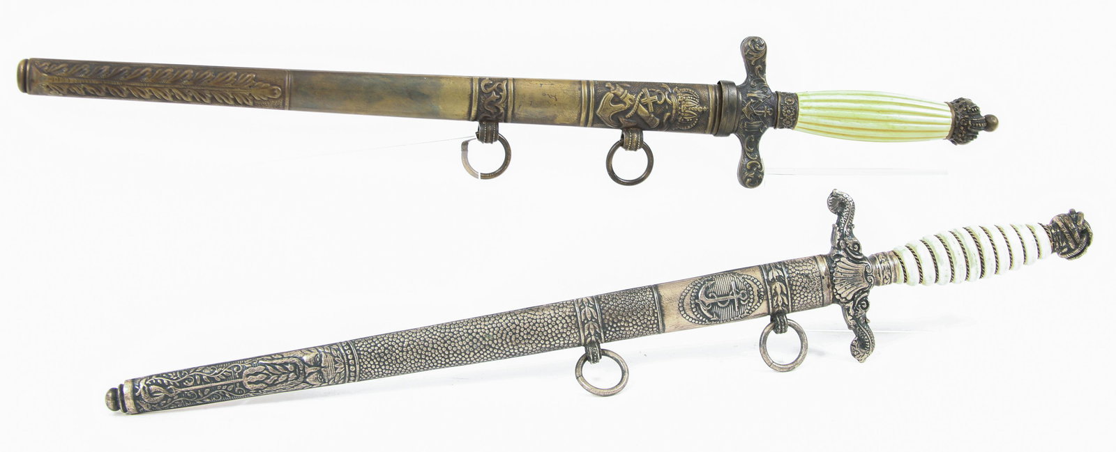 REPRODUCTION AUSTRO-HUNGARIAN NAVY DRESS DAGGERS: REPRODUCTION AUSTRO-HUNGARIAN NAVY DRESS DAGGERS - LOT OF 2 Lot of two reproduction WWI Austro-Hungarian Navy dress daggers with scabbards. Overall length: 17"