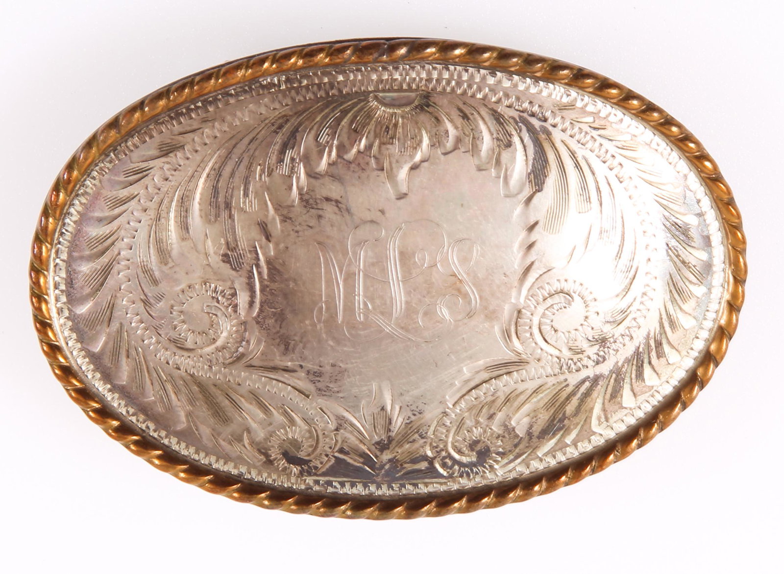 COMSTOCK STERLING SILVER BELT BUCKLE: COMSTOCK STERLING SILVER BELT BUCKLE Comstock sterling silver silversmiths belt buckle, monogrammed "MLS" with bright cut scroll work and gilt border. Size: 3 x 2" Weight: 40.1 grams