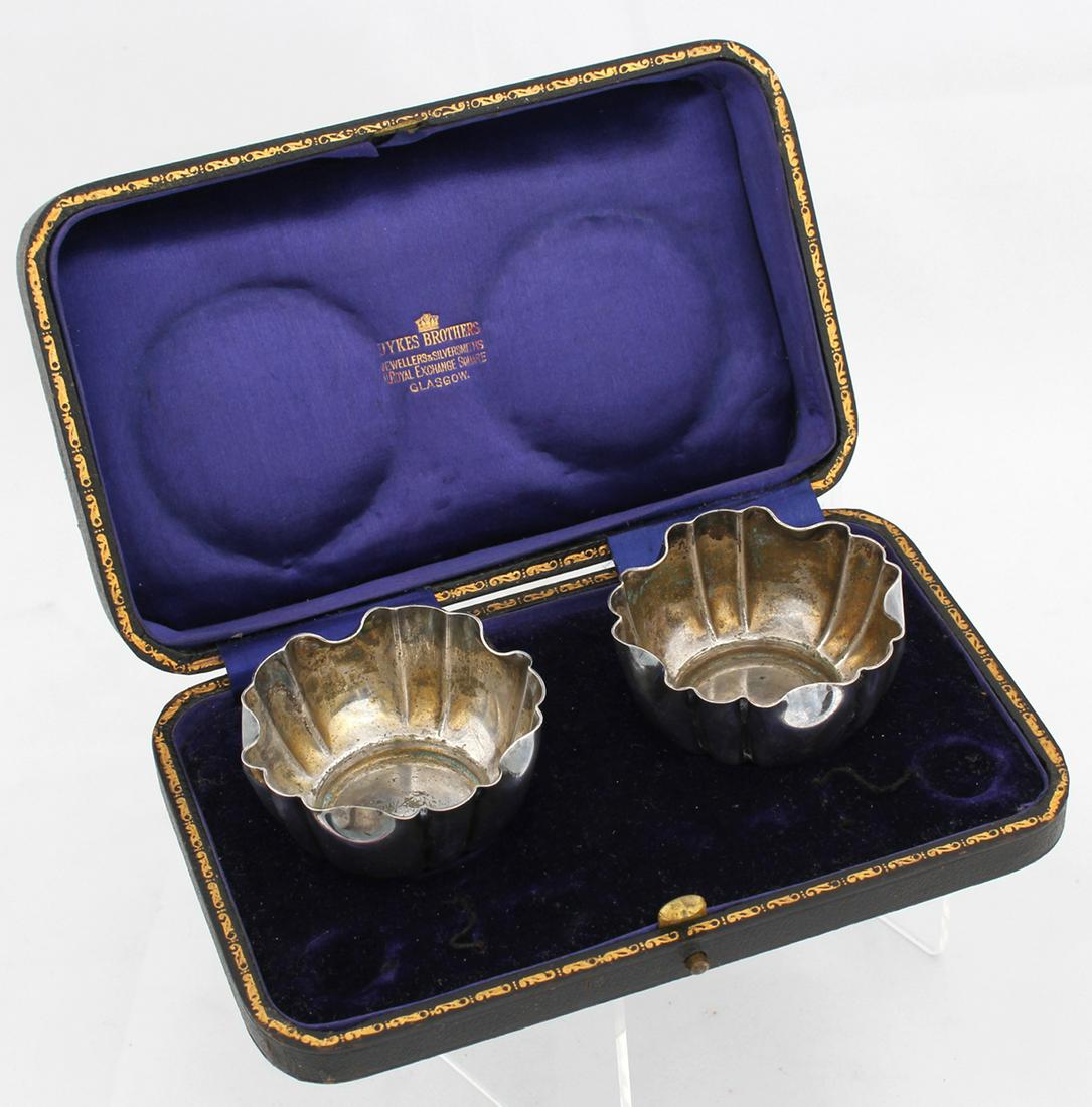 DYKES BROTHERS STERLING SALT CELLARS: DYKES BROTHERS STERLING SALT CELLARS Dykes Brothers sterling silver salt cellars, with lined case. Size: 2 x 1 1/4" Weight: 57.4 grams