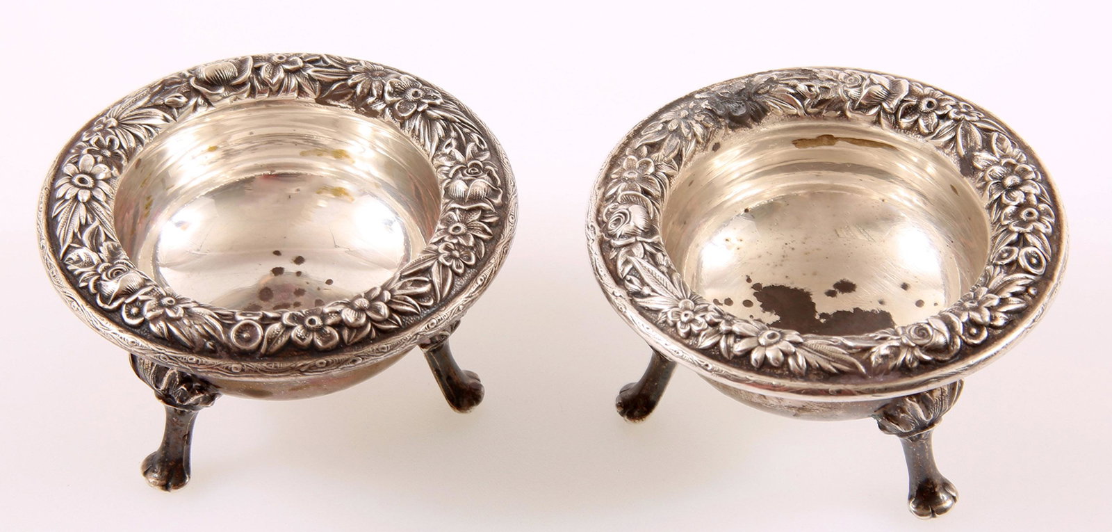 STERLING SILVER S. KIRK & SON REPOUSSE SALT CELLARS: STERLING SILVER S. KIRK & SON REPOUSSE SALT CELLARS Pair of solid sterling silver S. Kirk & Son repousse detailed salt cellars. Footed bases, signed on underside with pattern number 58. Size: 1.5x