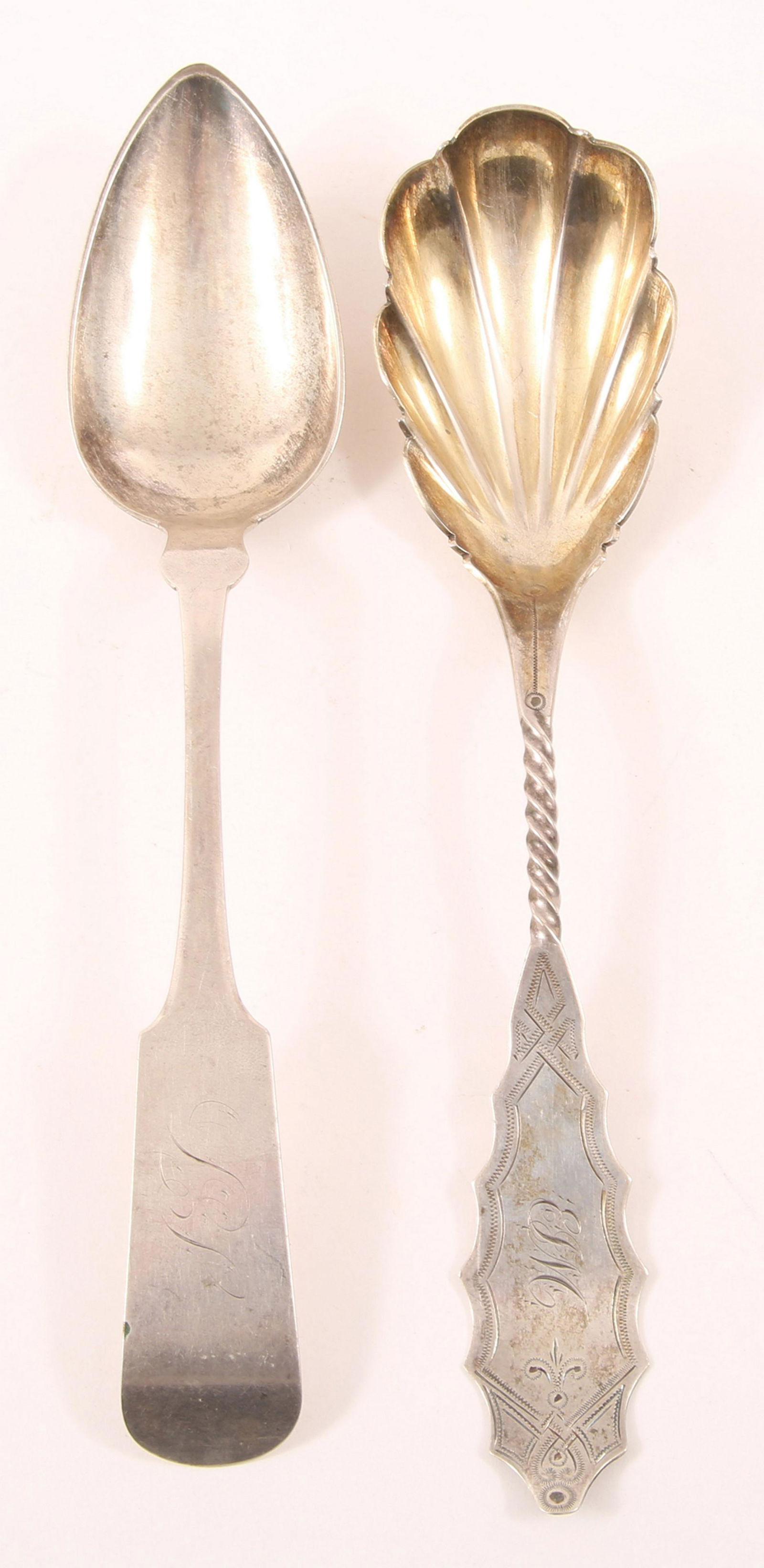 19TH C. AMERICAN COIN SILVER SPOONS - LOT OF TWO: 19TH C. AMERICAN COIN SILVER SPOONS - LOT OF TWO Lot includes: a James Butler scalloped bowl and twisted handle serving spoon with gold wash, and a W. Pitkin S.S. Newton large serving spoon. Size: 9"