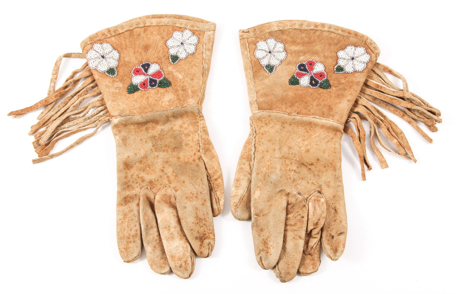 EARLY 20TH C. PLAINS NATIVE AMERICAN BEADWORK GAUNTLETS: EARLY 20TH C. PLAINS NATIVE AMERICAN BEADWORK GAUNTLETS Pair of Plains Native American beadwork gauntlets, circa early 20th century. Both feature three beadwork flowers, and fringe. Size: Fits g
