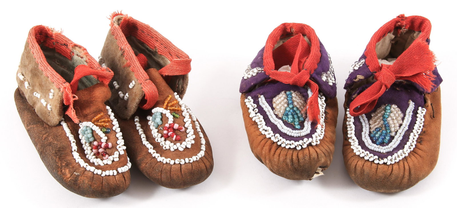 EARLY 20TH C. IROQUOIS BEADWORK CHILDREN'S MOCCASINS: EARLY 20TH C. IROQUOIS BEADWORK CHILDREN'S MOCCASINS Lot of two pairs of Iroquois beadwork children's moccasins. Made of brain tanned deer hide and light woven fabric. Size: 5" sole length
