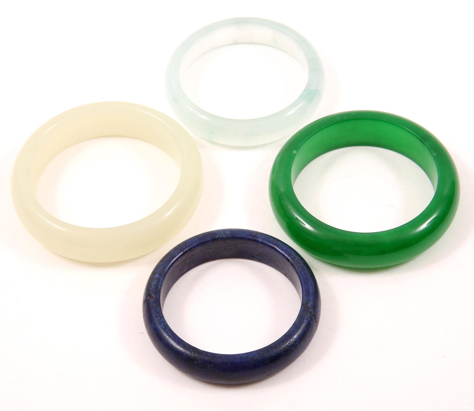 CARVED SOFTSTONE & LAPIS LAZULI BRACELETS - LOT OF 4: CARVED SOFTSTONE & LAPIS LAZULI BRACELETS - LOT OF 4 Lot of four carved bangle bracelets, includes: Three different shades of green softstone 7.5" internal circumference, 2.5" diameter 7.5" inter