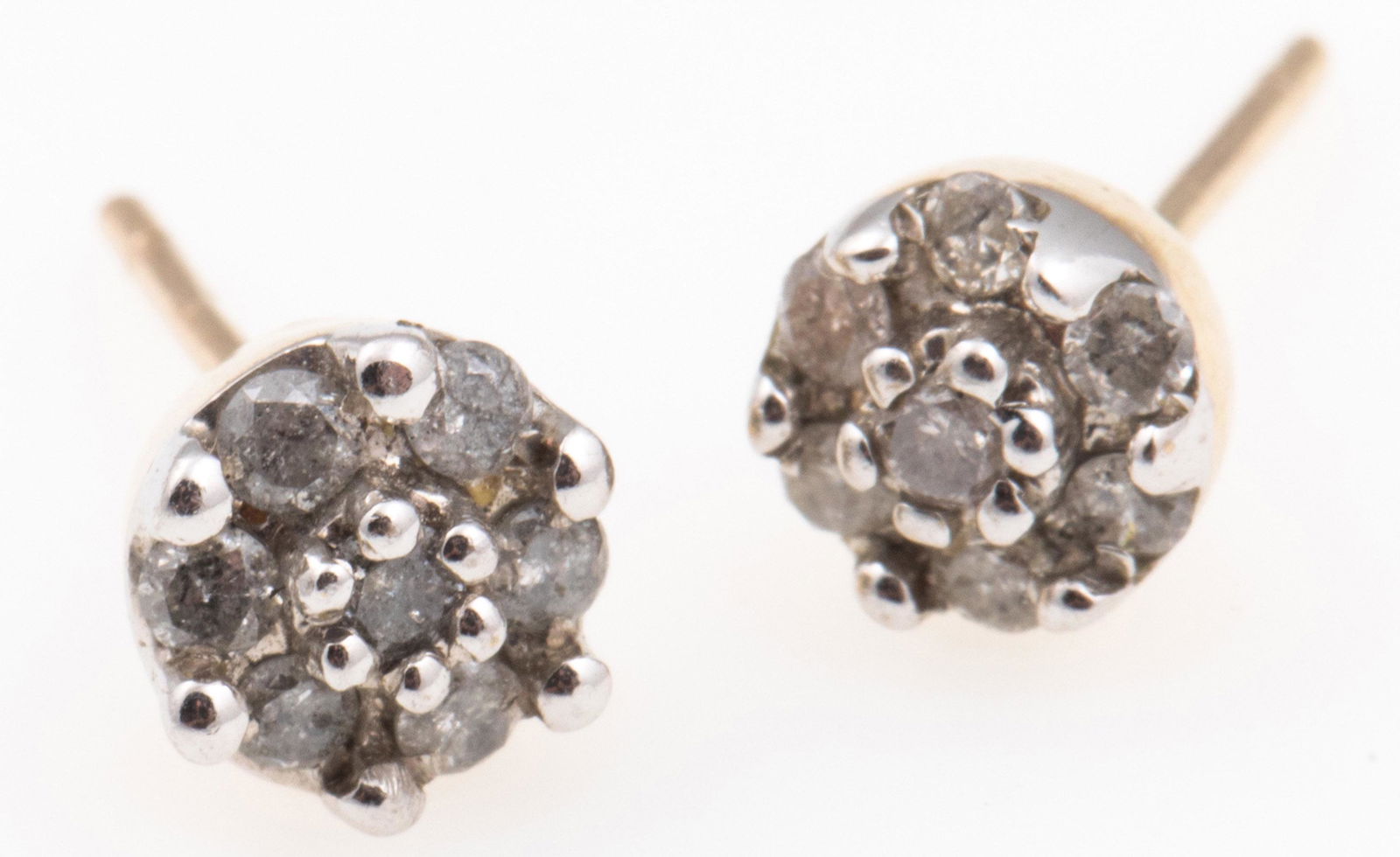 10K WHITE GOLD DIAMOND CLUSTER EARRINGS: 10K WHITE GOLD DIAMOND CLUSTER EARRINGS 10k white gold earrings with 7 .015 ct. diamonds on each. Weight: 1.0g