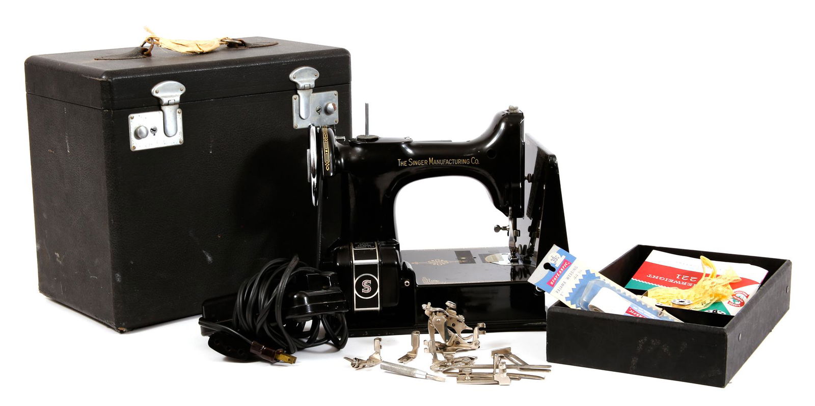 SINGER FEATHERWEIGHT 221 ELECTRIC SEWING MACHINE: SINGER FEATHERWEIGHT 221 ELECTRIC SEWING MACHINE 1950s Singer Featherweight 221 electric sewing machine with case. Includes original manual, foot pedal, sewing feet, bobbins, and other sewing accessor