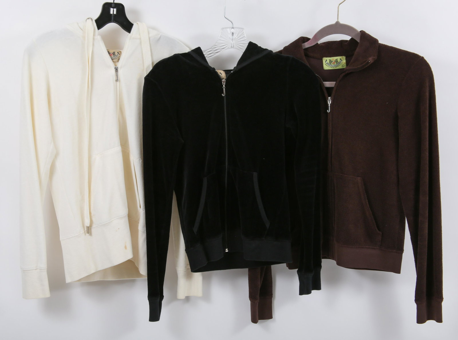 WOMEN'S JUICY COUTURE TRACK JACKETS - LOT OF 3: WOMEN'S JUICY COUTURE TRACK JACKETS - LOT OF 3 Three women's track jackets, by Juicy Couture. Includes: Brown terry cloth, size L (16.5" shoulder to shoulder) Cream velour, size M (14" shoulder 