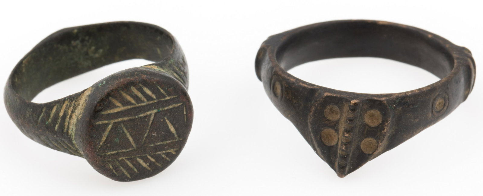 MEDIEVAL BRONZE SIGNET SHIELD RINGS - LOT OF 2: MEDIEVAL BRONZE SIGNET SHIELD RINGS - LOT OF 2 Lot of two Medieval bronze signet shield rings, approximately 14th to 16th century. Weight: 18.1g total Size: 8 & 11
