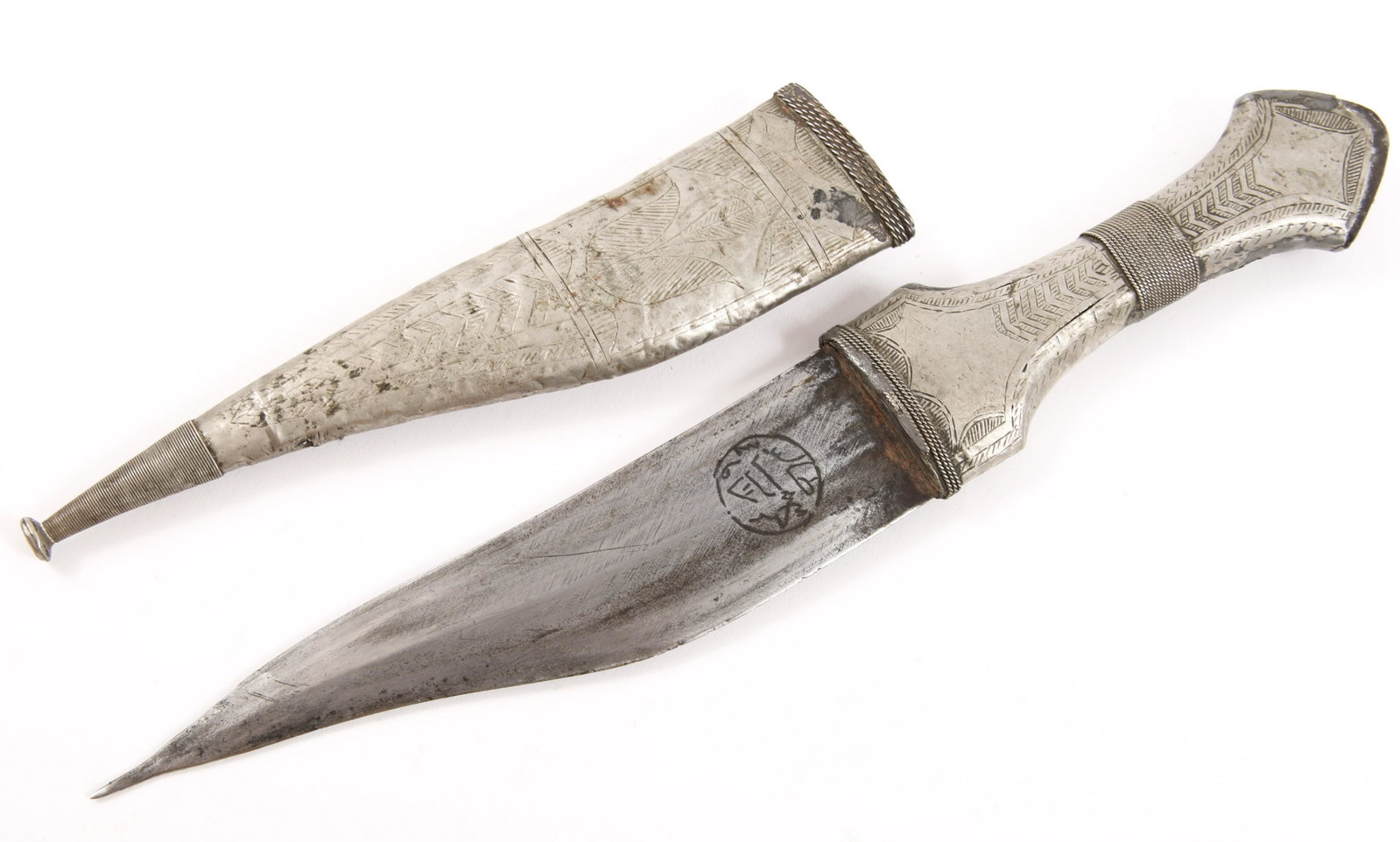 ARABIAN JANBIYA SHIBRIYA KHANJAR DAGGER WITH SCABBARD: ARABIAN JANBIYA SHIBRIYA KHANJAR DAGGER WITH SCABBARD Arabian white metal Janbiya dagger with etched scabbard and handle, early 20th century.