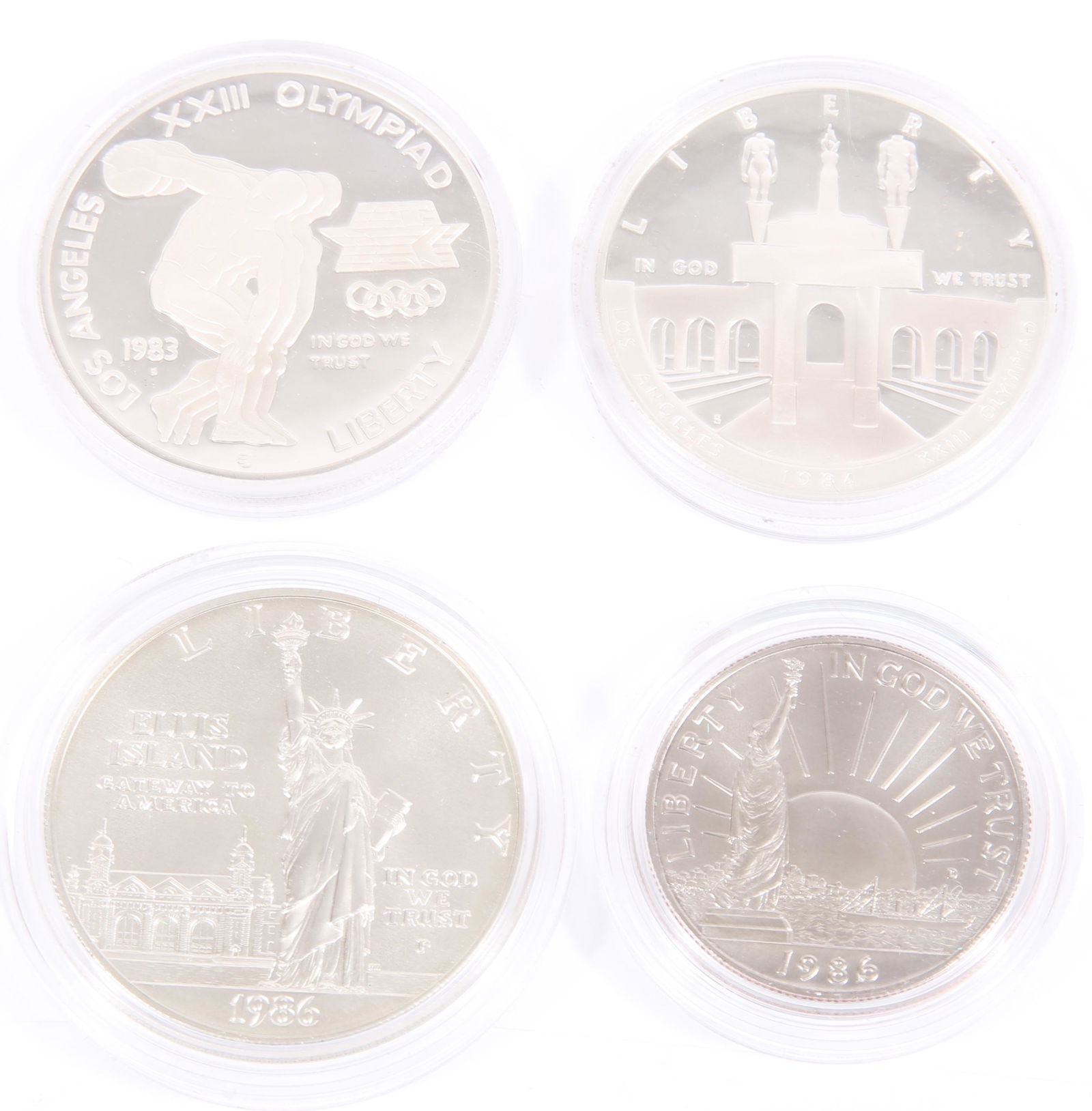 1983 & 1986 UNITED STATES MINT SILVER COIN SETS: 1983 & 1986 UNITED STATES MINT SILVER COIN SETS To include: a U.S. Mint 1983/1984 two coin silver dollar set with the Olympic commemorative silver dollars, and a 1986 Liberty two coin set as well. Pre