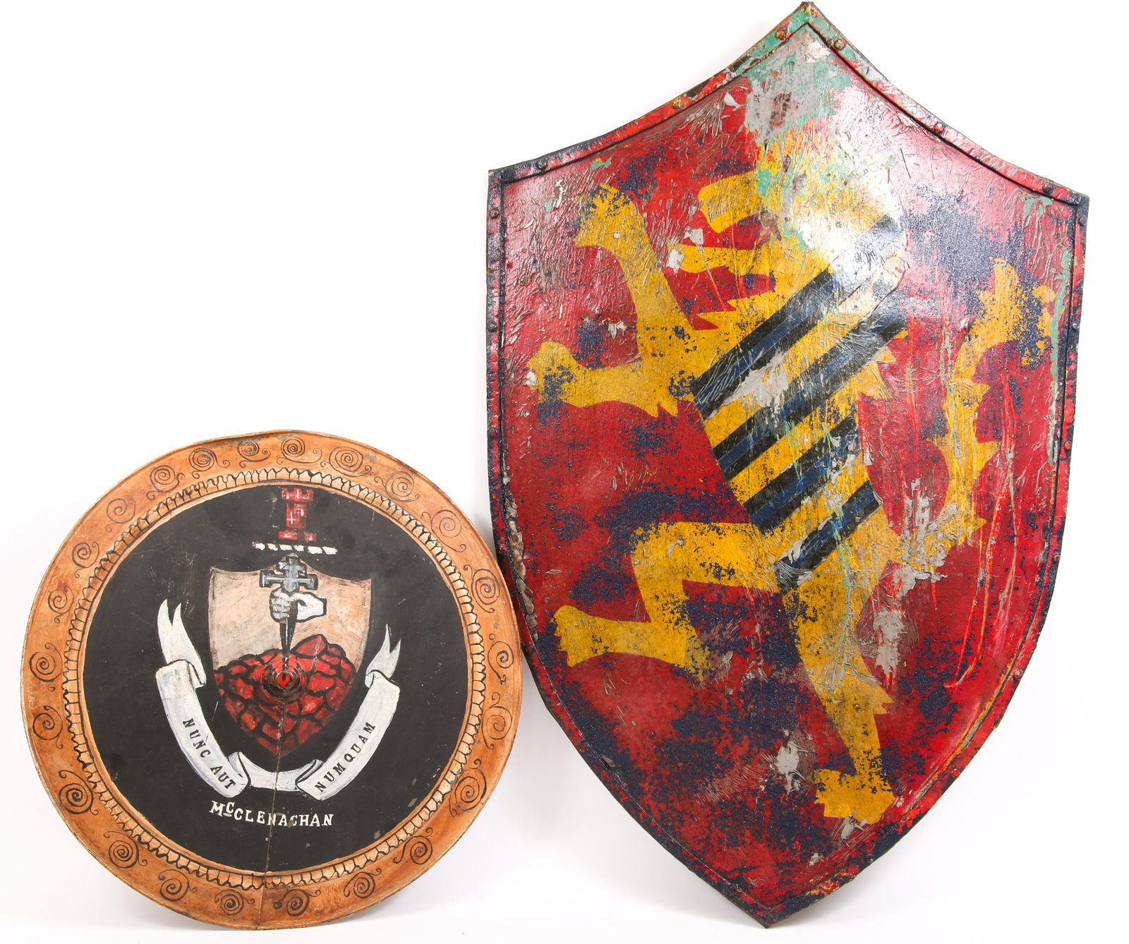 THEATER MEDIEVAL HERALDIC SHIELDS - LOT OF 2: THEATER MEDIEVAL HERALDIC SHIELDS - LOT OF 2 Lot of two theater medieval style heraldic shields. To include: Heater shield with rampant lion, 23.5 x 34". Round shield with "McClendon" coat of ar