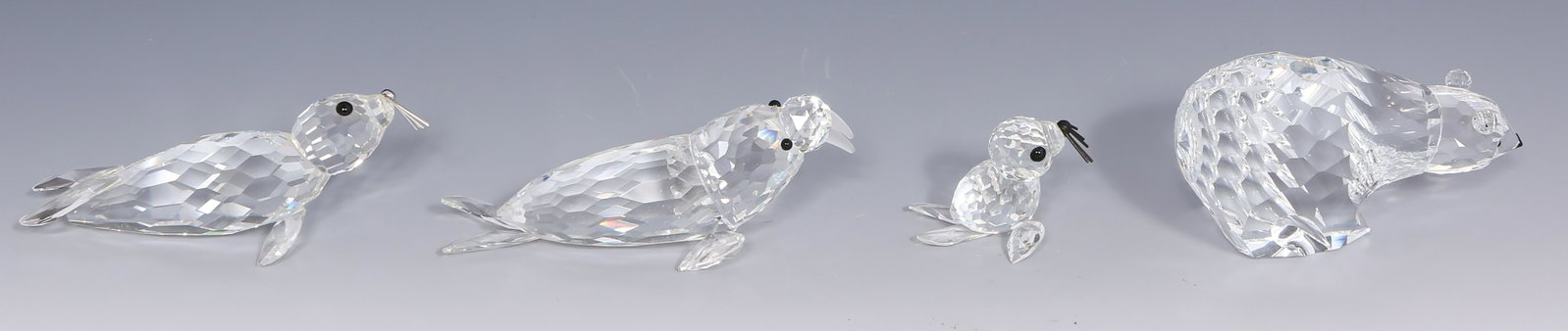 SWAROVSKI SCS CRYSTAL POLAR ANIMAL FIGURINES - LOT OF 4: SWAROVSKI SCS CRYSTAL POLAR ANIMAL FIGURINES - LOT OF 4 Lot of 4 Swarovski silver crystal polar animal figurines. Includes: Walrus, 4". SCS Polar Bear, 3.50". Seal, 1.50". SCS Sea Lion,