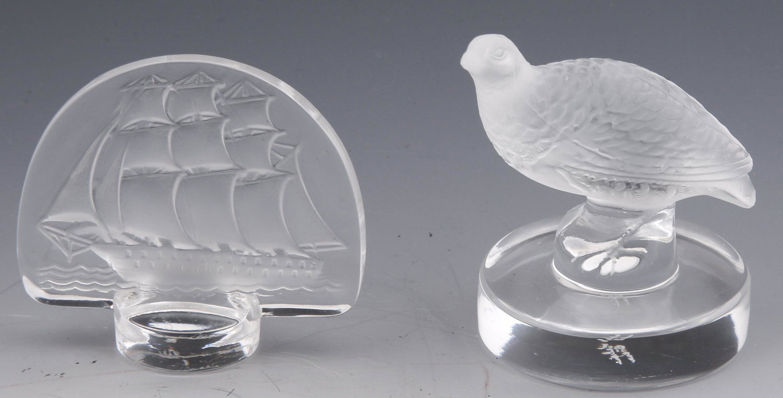LALIQUE PARTRIDGE & SAILING CLIPPER SHIP PAPERWEIGHTS: LALIQUE PARTRIDGE & SAILING CLIPPER SHIP PAPERWEIGHTS Lot of 2 signed Lalique paperweights, including: Sailing clipper ship, intaglio, size: 2.5 x 2.25", signed on side of base. Partridge, size: 2 x 2