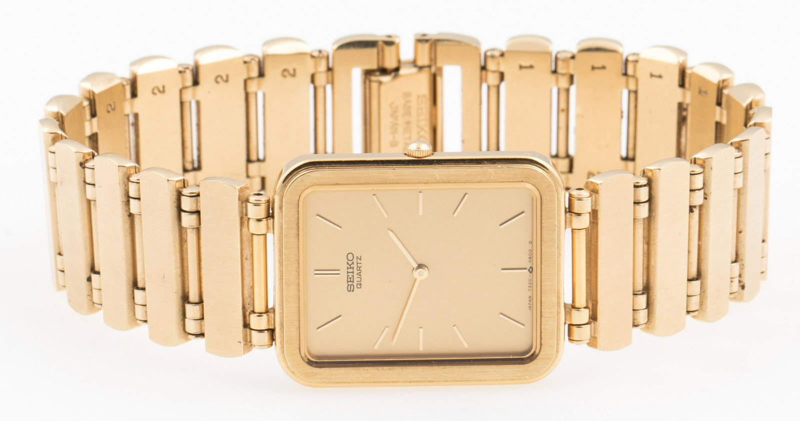 WOMEN'S SEIKO QUARTZ GOLD-TONE WATCH: WOMEN'S SEIKO QUARTZ GOLD-TONE WATCH Women's Seiko-Quartz gold-tone watch with stainless steel back. Square gold-tone face with gold-tone hands and dashes for numbers. Length: 8". Size: 23mm Weight: 5