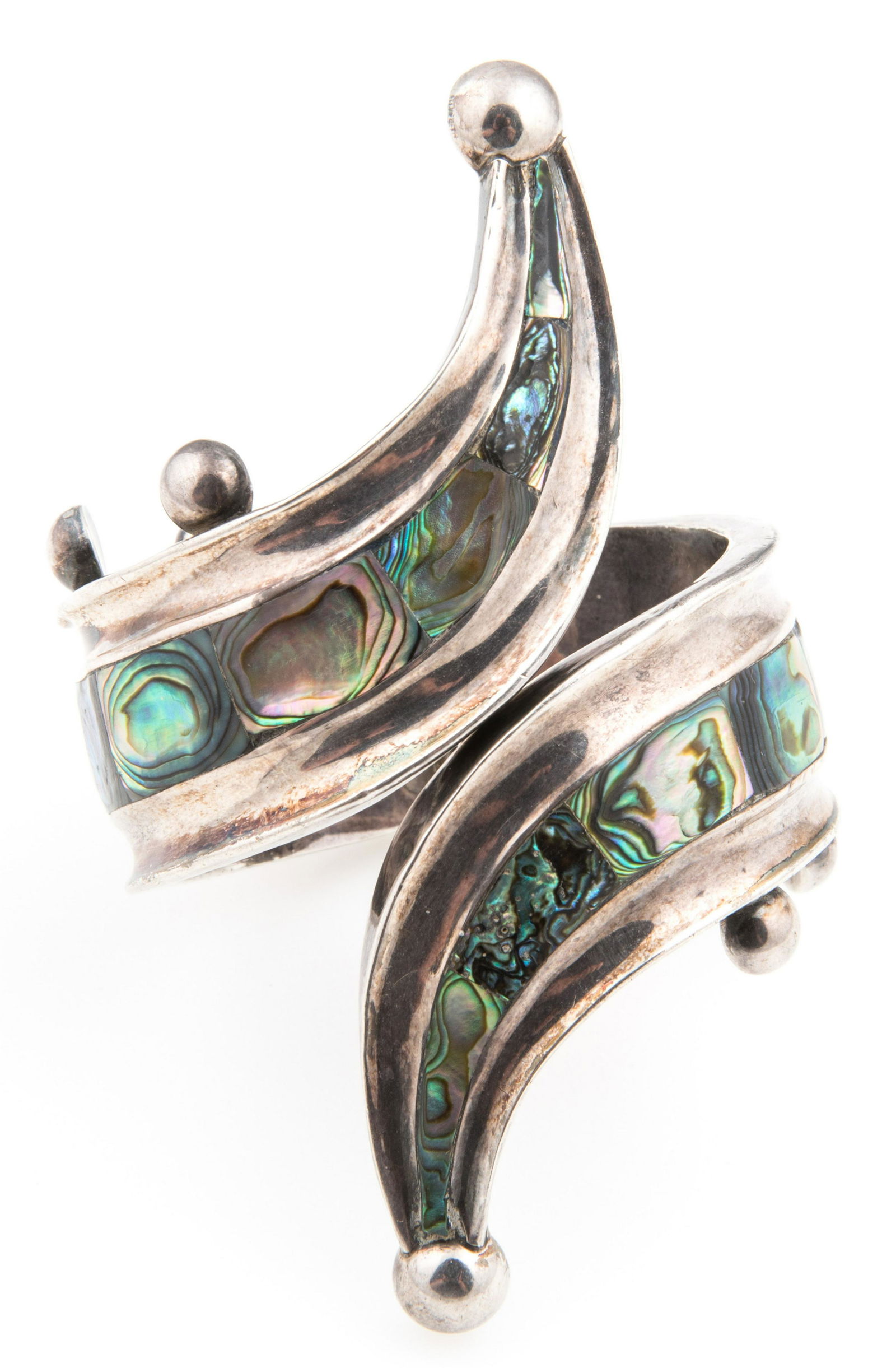 TAXCO STERLING SILVER & ABALONE SHELL HINGED CUFF: TAXCO STERLING SILVER & ABALONE SHELL HINGED CUFF Sterling silver Taxco hinged cuff, featuring inlaid slices of abalone shell. Stamped with the Eagle 3 marking to the interior.