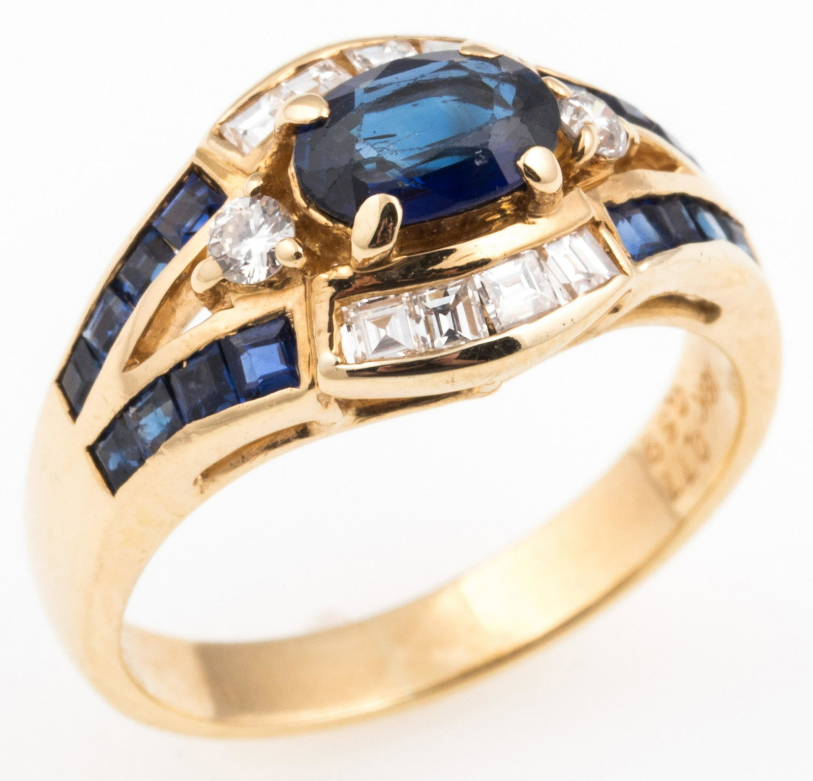 18K YELLOW GOLD SAPPHIRE & DIAMOND FASHION RING: 18K YELLOW GOLD SAPPHIRE & DIAMOND FASHION RING 18K yellow gold fashion ring with: One 5 x 7 mm oval cut blue sapphire. Sixteen 1 x 1 mm princess cut sapphires. Two 2 mm (0.03 ct) round white diamonds