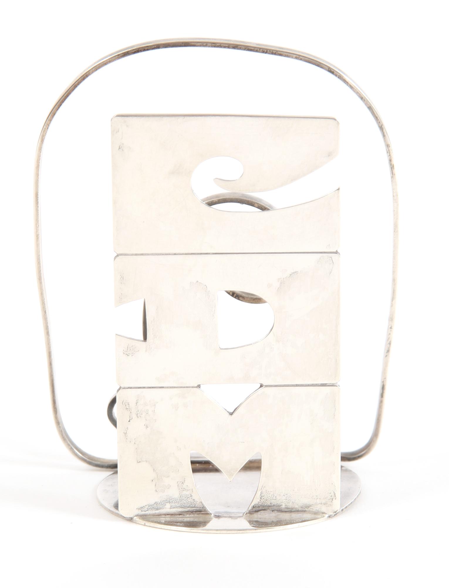 LEONORE DOSKOW STERLING SILVER NAPKIN HOLDER: LEONORE DOSKOW STERLING SILVER NAPKIN HOLDER Leonore Doskow sterling silver napkin holder, with "CDM" monogram. Size: 3.5 x 2.75" Weight: 60.6g