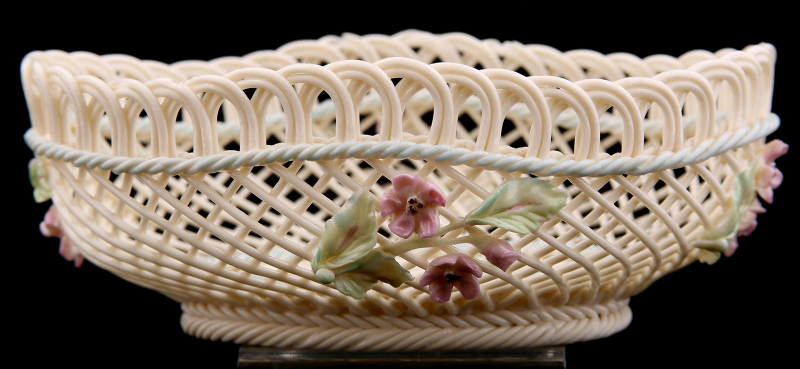 BELLEEK WOVEN PORCELAIN OVAL BASKET: BELLEEK WOVEN PORCELAIN OVAL BASKET Belleek woven porcelain oval basket with floral accents. In original case. Marked "Belleek Ireland" on bottom. Basket size: Box size: 9.25 x 9.25"</