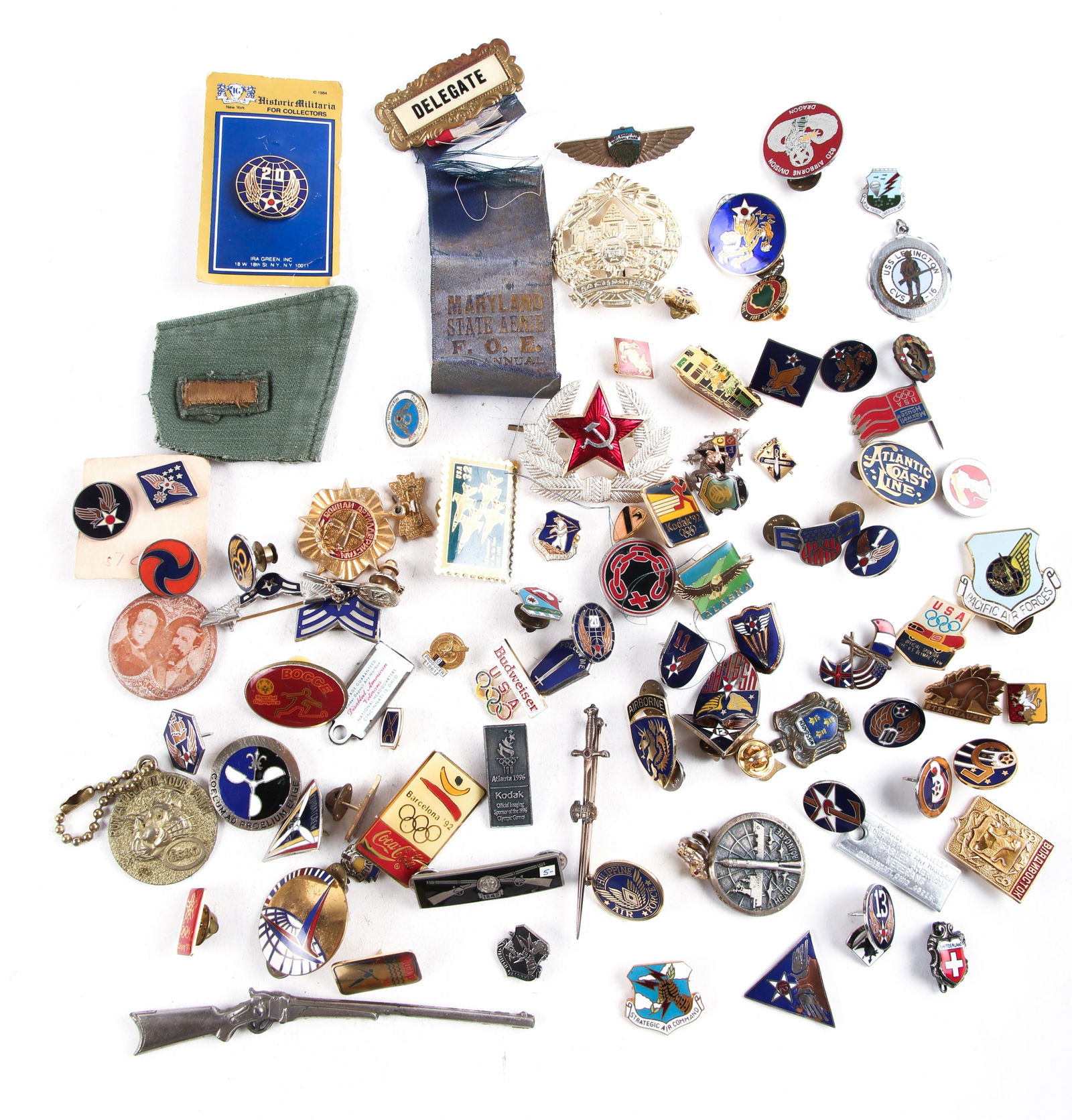 MILITARY AND CIVILIAN PINS, BADGES, & MORE ESTATE LOT: MILITARY AND CIVILIAN PINS, BADGES, & MORE ESTATE LOT Estate lot of 60+ pins, keychains, badges, and more. Themes include military, olympic, travel, and fraternal order items. 