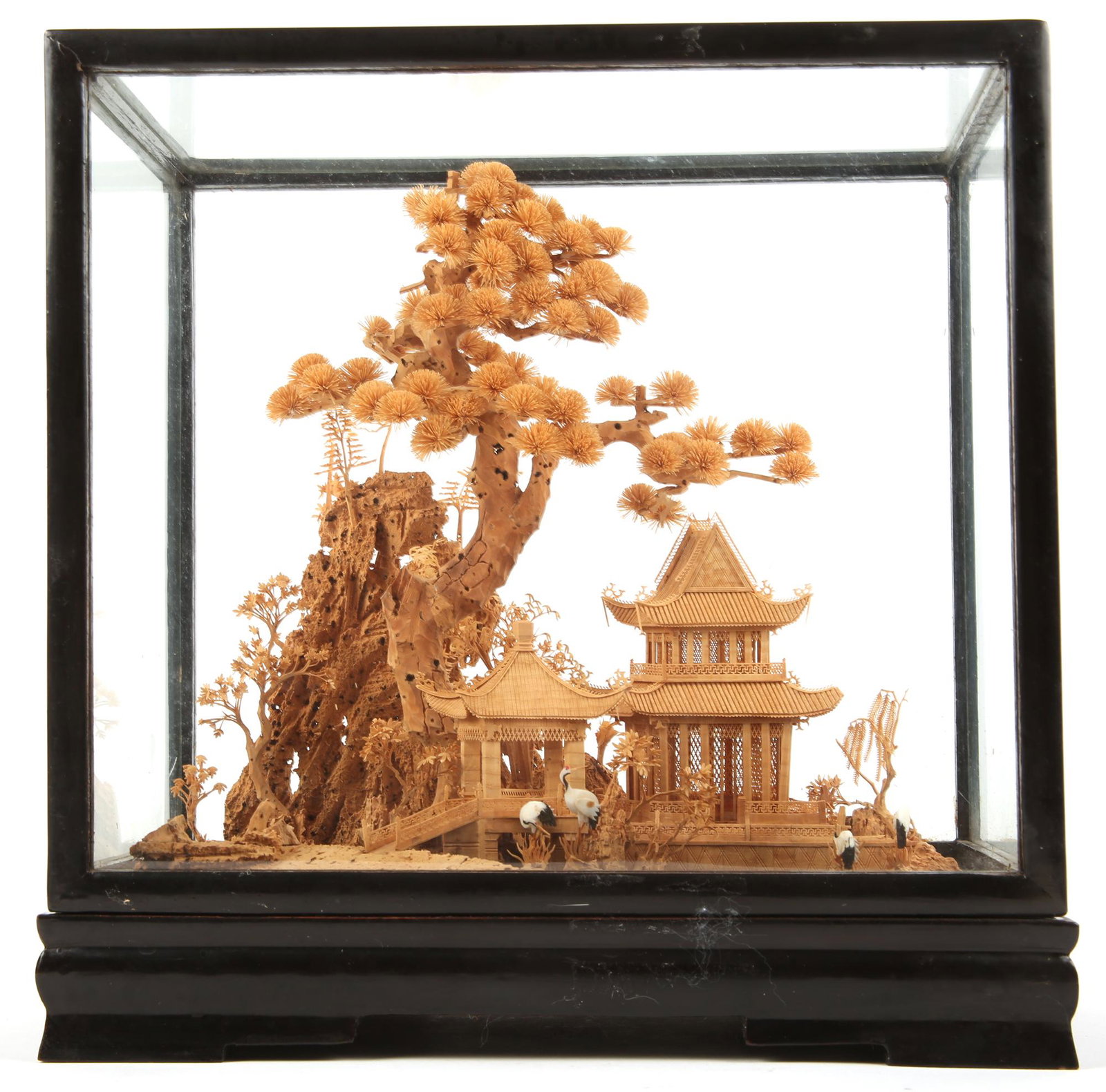 CHINESE CORK CARVING IN CASE: CHINESE CORK CARVING IN CASE Chinese carved cork encased in black lacquer frame glass case. Depicts a landscape scene with pine, cranes, pagoda and mountain.