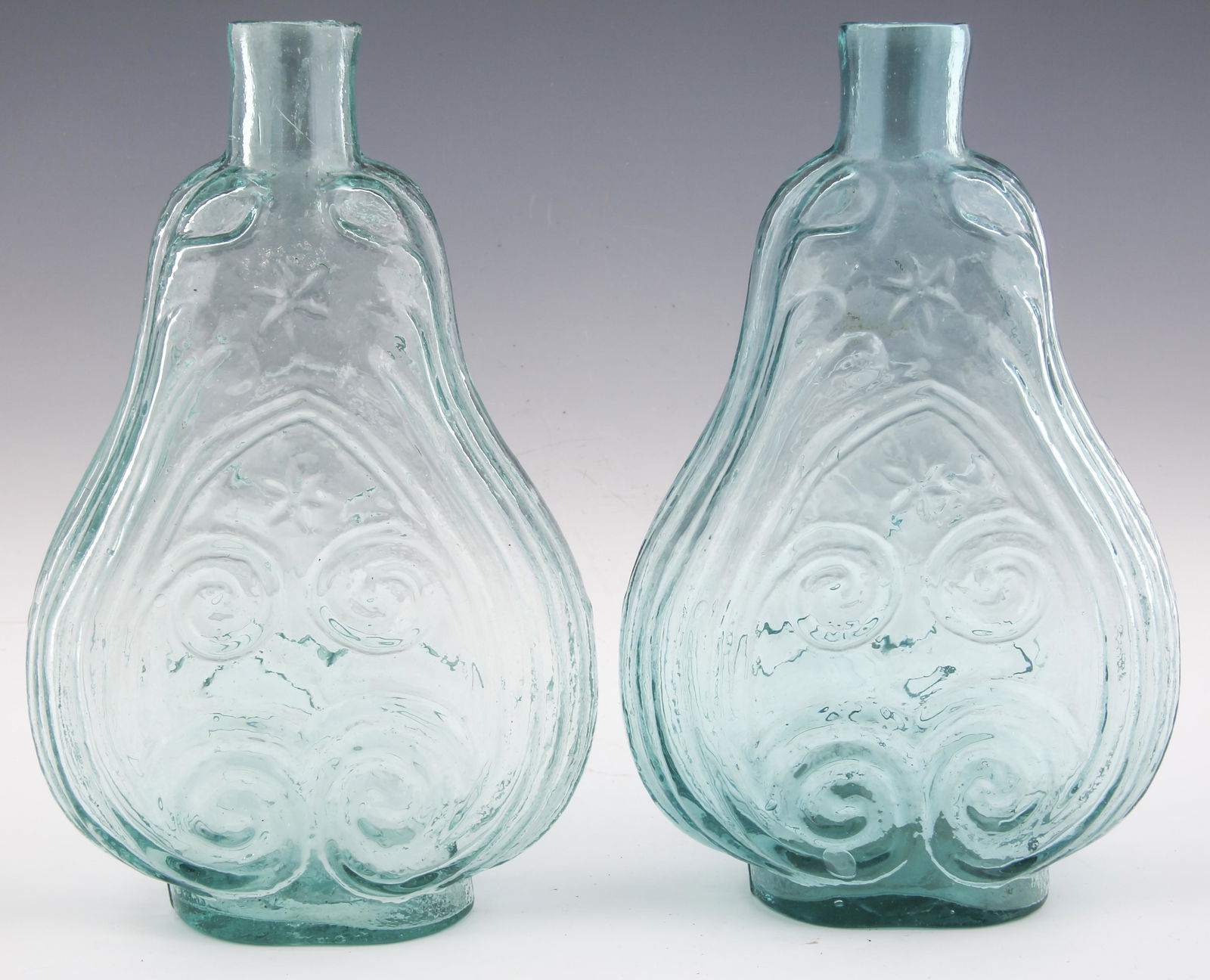 19TH C. VIOLIN SCROLL AND STAR FLASKS - LOT OF 2: 19TH C. VIOLIN SCROLL AND STAR FLASKS - LOT OF 2 Lot of two 19th century violin scroll and star flasks. Both have unfinished pontil scars. Flasks measure 5.5 x 2.25 x 8.75". Size: 5.5 x 2.25 x 8.75"