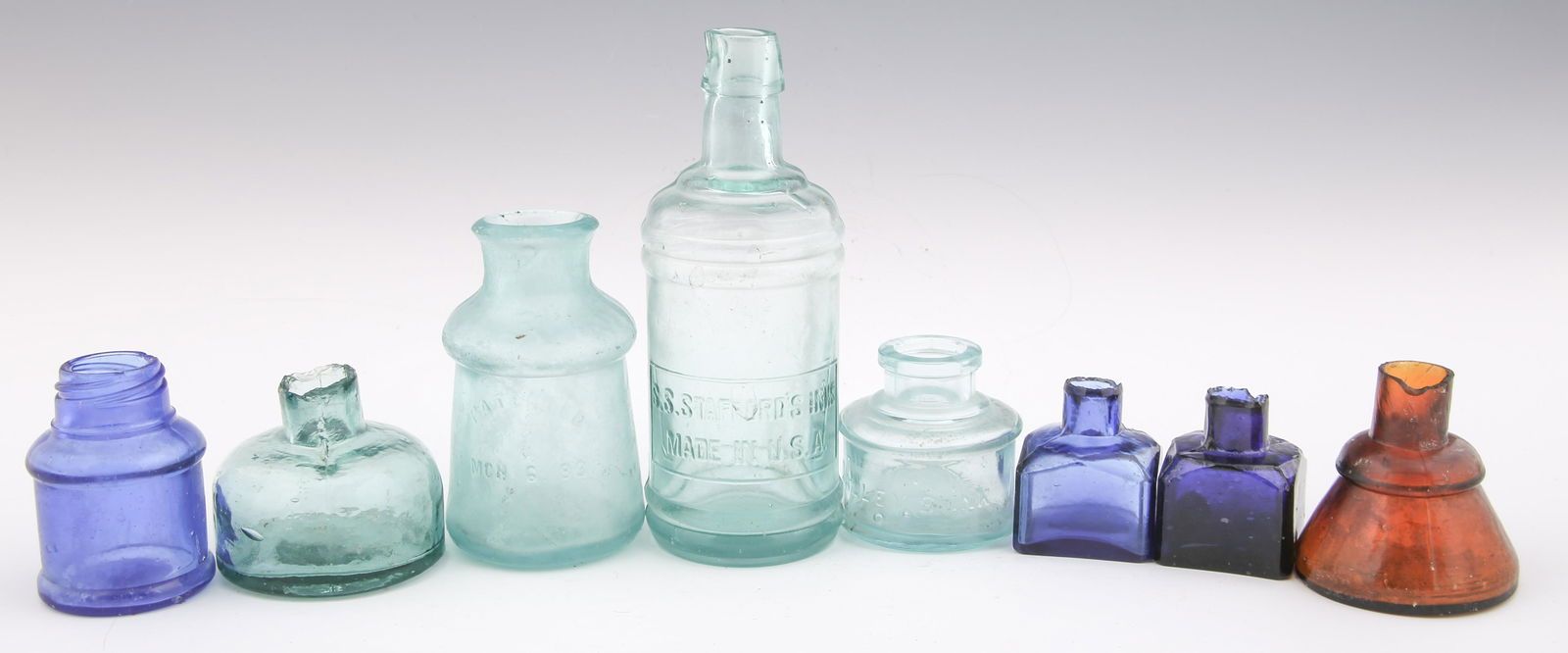 19TH C. GLASS INKWELLS & BOTTLES - LOT OF 8: 19TH C. GLASS INKWELLS & BOTTLES - LOT OF 8 Lot of eight 19th century glass inkwells and bottles, includes: Three cobalt blue inkwells. One root beer color inkwell. One aqua color inkwell. Dalley's