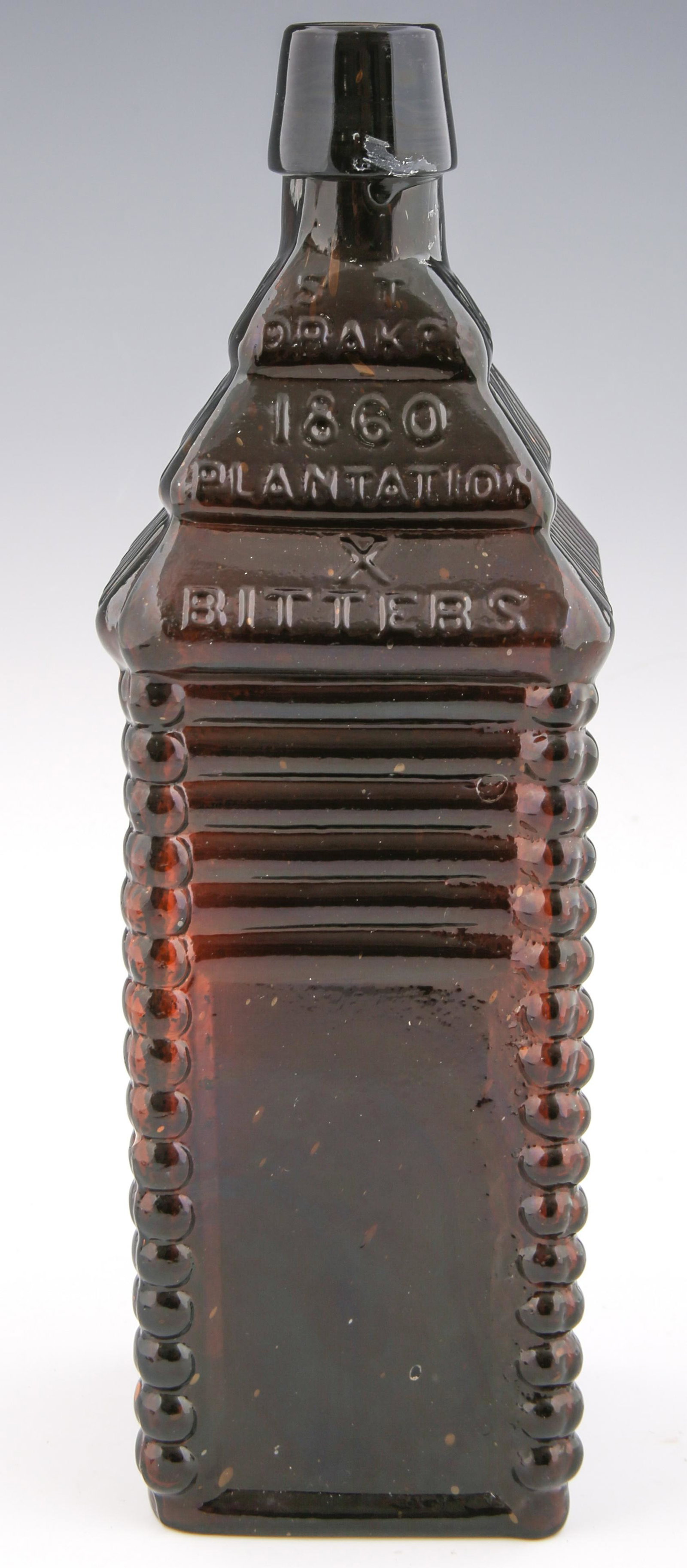 ST DRAKE'S PLANTATION BITTERS BOTTLE: ST DRAKE'S PLANTATION BITTERS BOTTLE ST Drake's 1860 Plantation Bitters bottle. Marked "ST DRAKES 1860 X BITTERS" on one side and "PATENTED 1862" on the opposite side. Bottom has three rounded bumps i