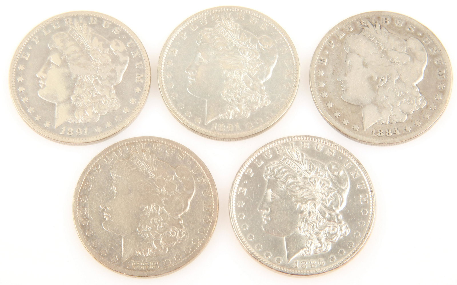 UNITED STATES MORGAN SILVER DOLLARS - 1883-1891: UNITED STATES MORGAN SILVER DOLLARS - 1883-1891 Lot of five silver U.S. Morgan dollars, to include 1883 O, 1884 O, 1886 P, and (2) 1891 O.