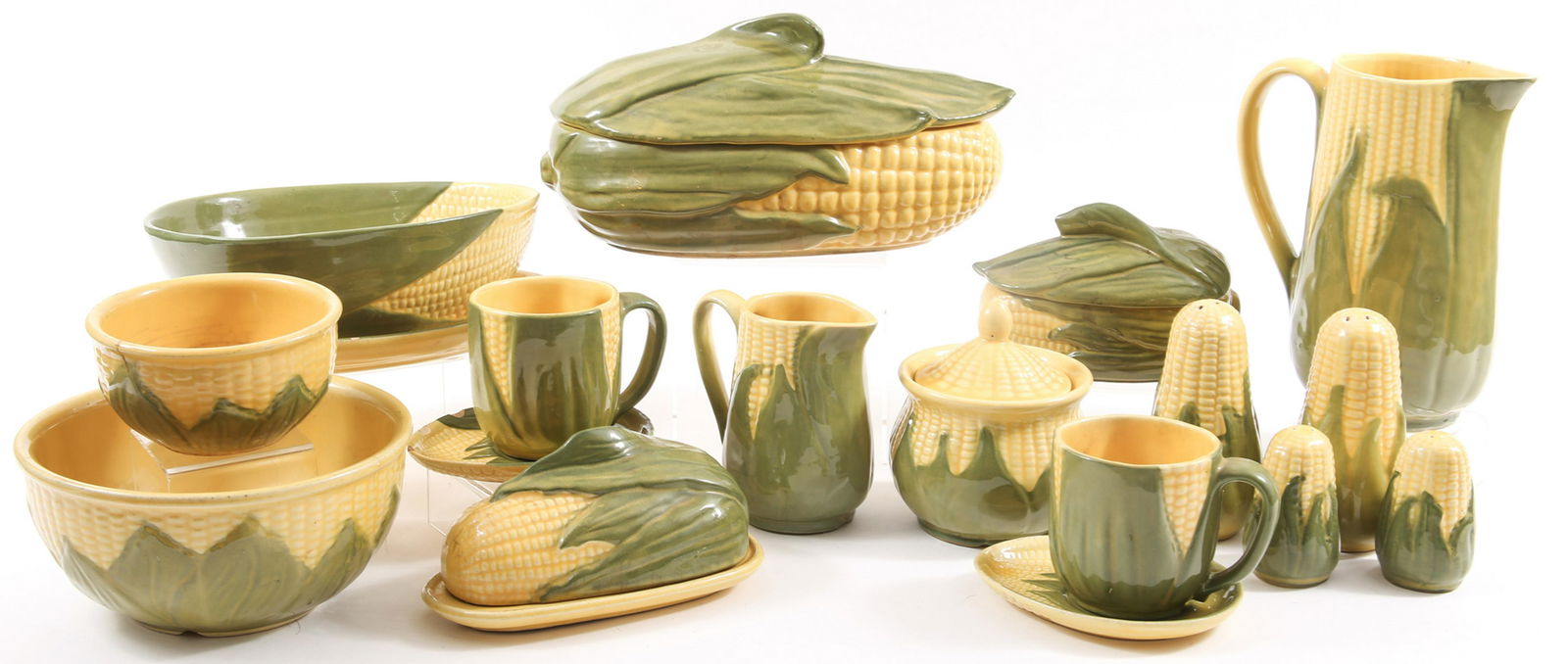 SHAWNEE CORN KING POTTERY SERVEWARE: SHAWNEE CORN KING POTTERY SERVEWARE Shawnee Corn King pottery serveware, includes: Butter dish 2 tea cups and saucers 4 salt and pepper shakers, 3" and 5.5" Small covered dish, 6 x