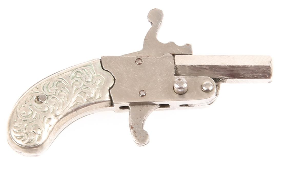 1930's AUSTRIA 2mm BERLOQUE PINFIRE PISTOL: 1930's AUSTRIA 2mm BERLOQUE PINFIRE PISTOL 1930's Austrian 2mm Berloque pinfire pistol, nickel plated brass with scrolling design on grip, no bail, marked "AUSTRIA" on barrel. Size: 1.5"