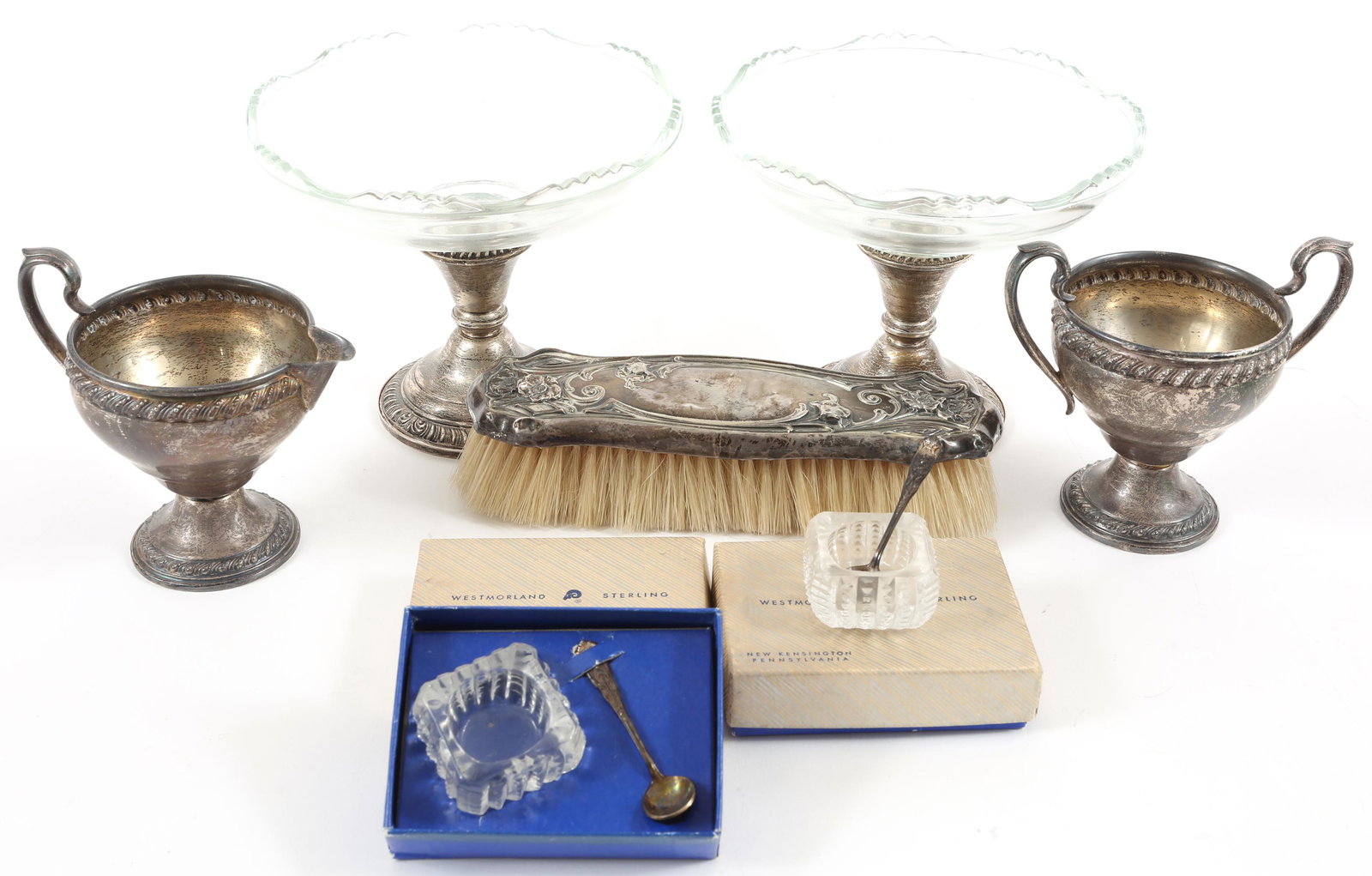 WEIGHTED STERLING SILVER - COMPOTES, SERVEWARE, BRUSH: WEIGHTED STERLING SILVER - COMPOTES, SERVEWARE, BRUSH Weighted sterling silver items, includes: Sugar Creamer Two glass bowl compotes Brush Two Westmoreland glass salt cellars with sterling silver s