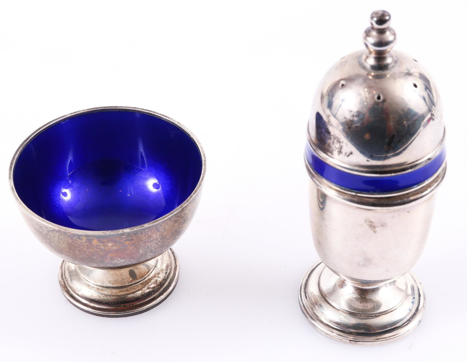 STERLING SILVER THOMAE COMPANY SALT & PEPPER ENAMEL SET: STERLING SILVER THOMAE COMPANY SALT & PEPPER ENAMEL SET Sterling silver salt and pepper set by The Thomae Company with cobalt blue enamel accent to the shaker and bowl of cellar. Size: 1.75
