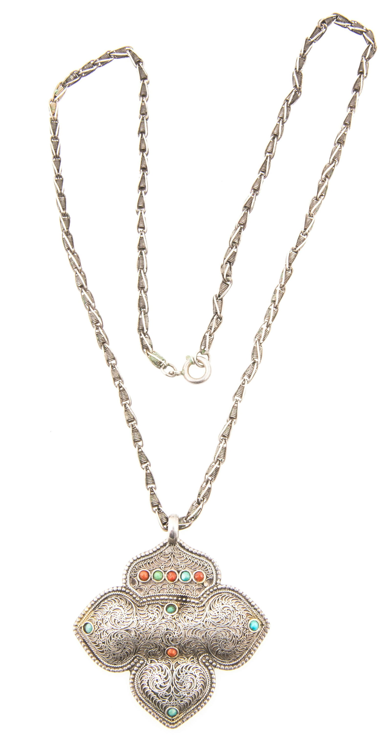 NEPAL STERLING SILVER FILIGREE TURQUOISE CORAL NECKLACE: NEPAL STERLING SILVER FILIGREE TURQUOISE CORAL NECKLACE Sterling silver pendant on chain, decorated with scrolling filigree detail, turquoise, and coral cabochons. Marked "Nepal 925" on underside. Siz