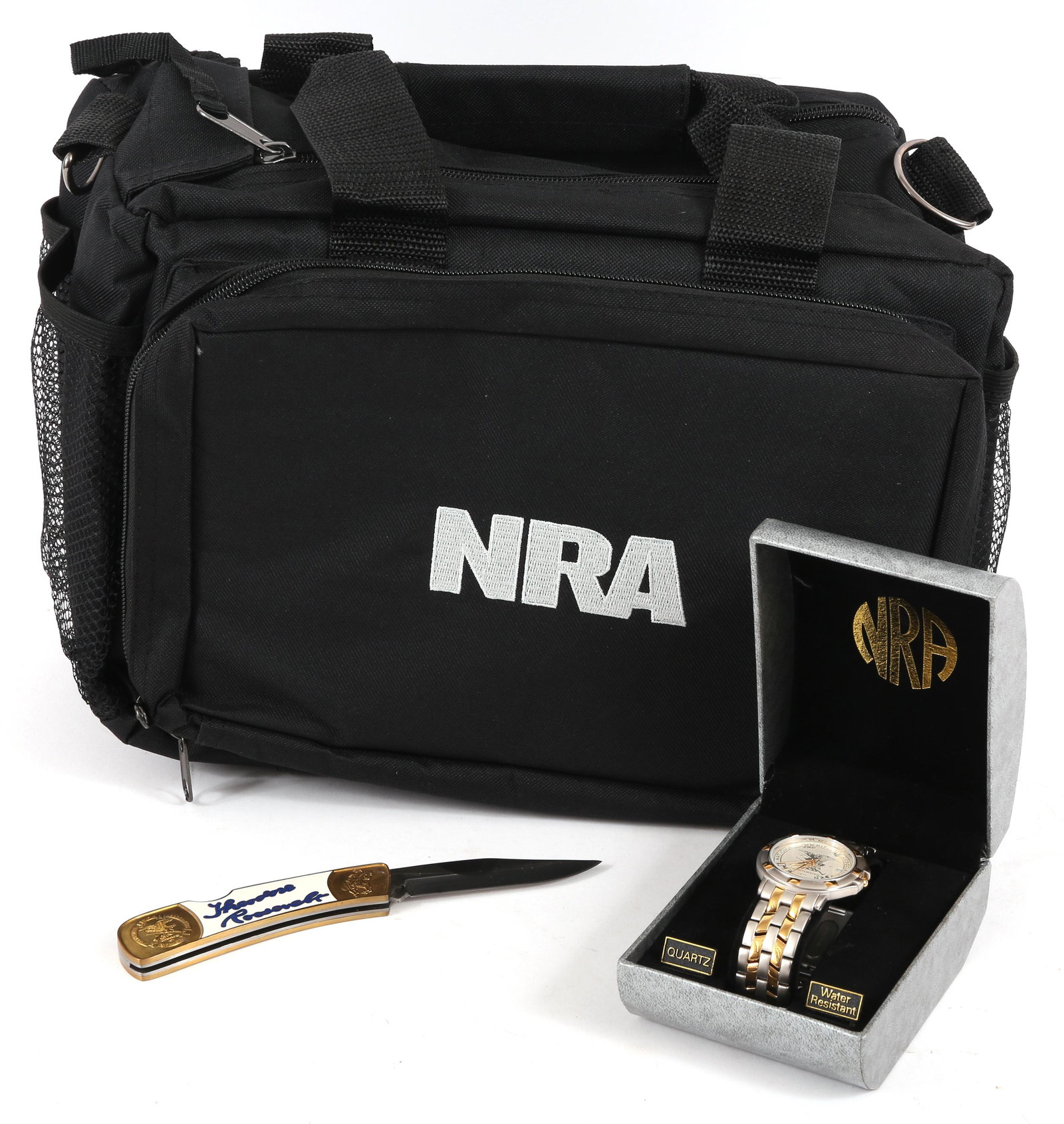 NRA PROMOTIONAL ITEMS - SATCHEL BAG, WRISTWATCH, KNIFE: NRA PROMOTIONAL ITEMS - SATCHEL BAG, WRISTWATCH, KNIFE NRA promotional items, to include: Black logo satchel bag Silver and gold tone wristwatch with original box Gold tone folding knife with