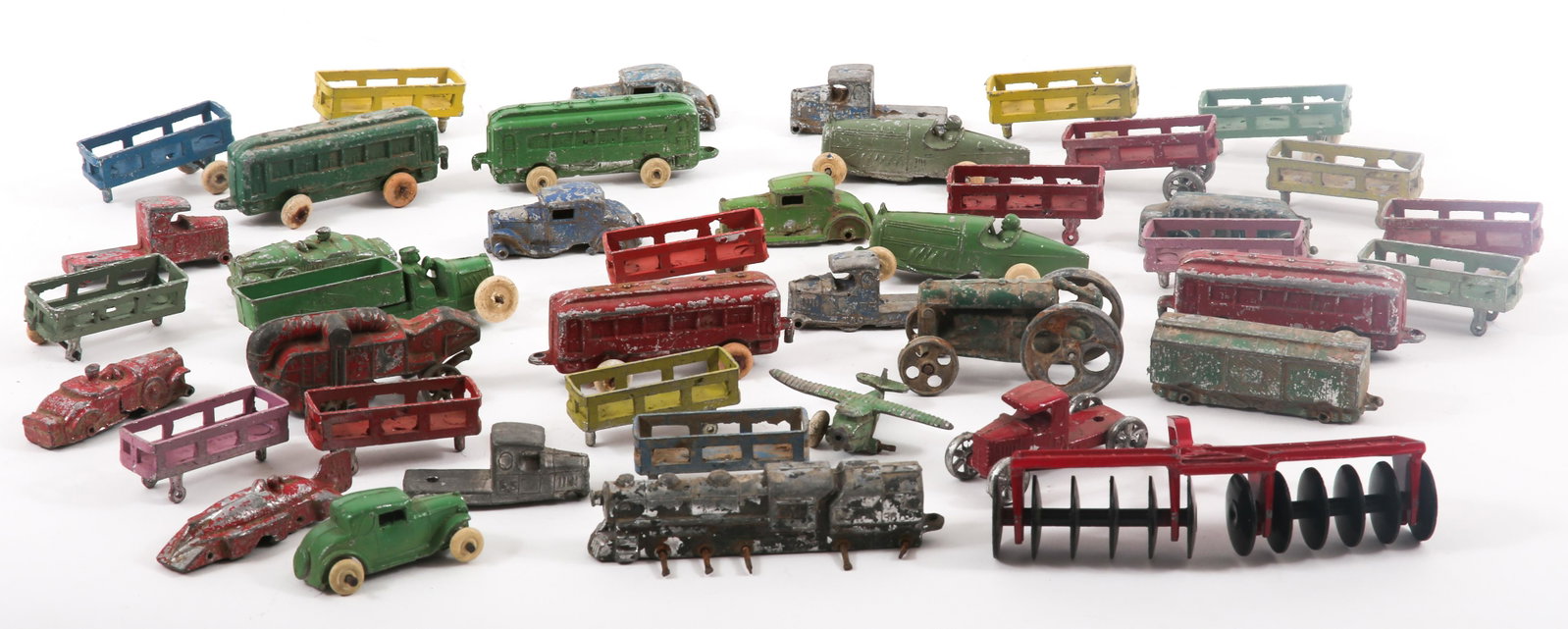 METAL TOY CARS, TRUCKS, TRAIN CARS & MORE - LOT OF 42: METAL TOY CARS, TRUCKS, TRAIN CARS & MORE - LOT OF 42 Lot of 42 metal toys, including: Cars Train cars Trucks Trailers Disk plow, marked by Ertl Co. Almost all are marke
