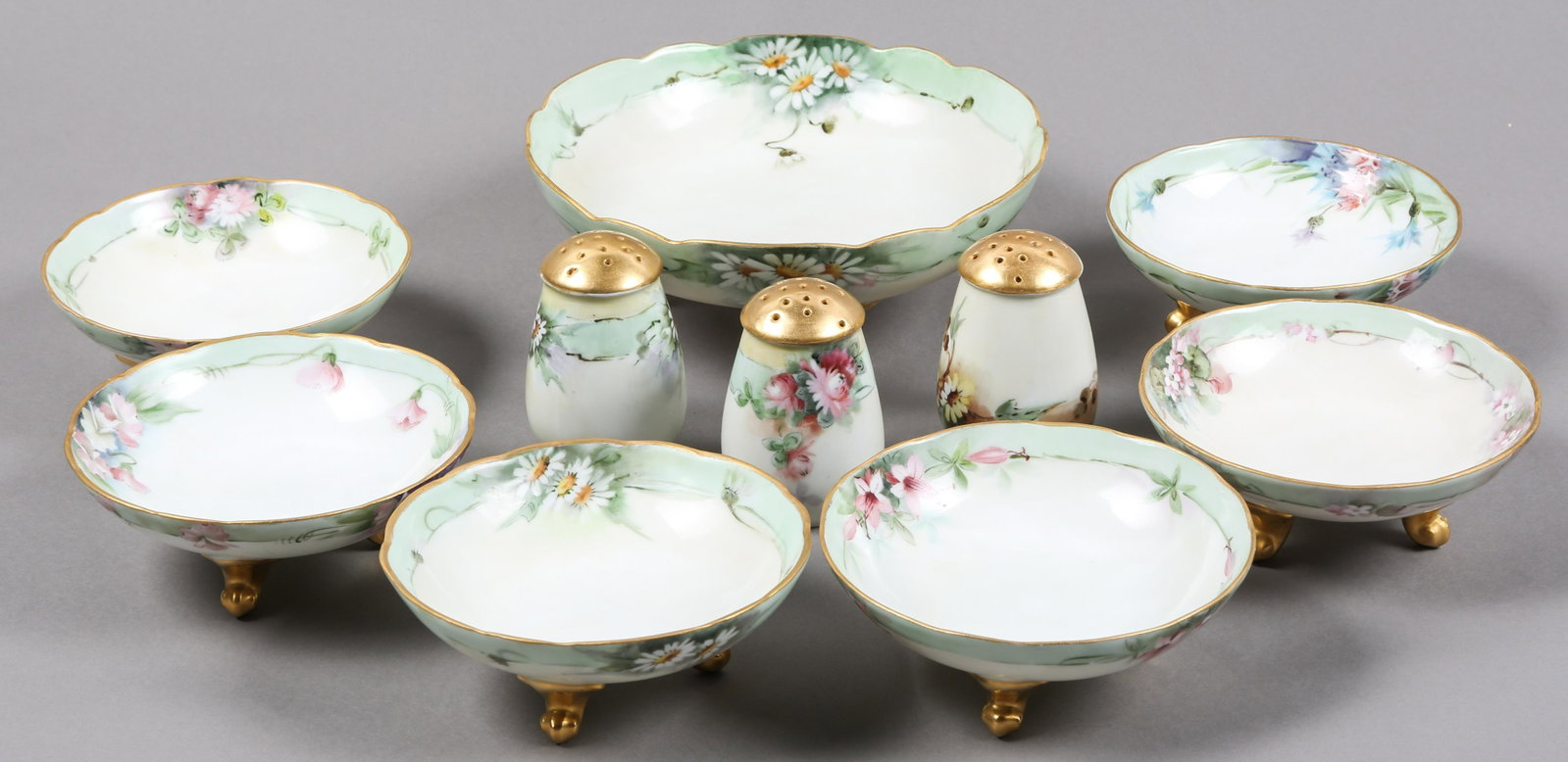 HAND PAINTED FLORAL BAVARIAN & AUSTRIAN PORCELAIN BOWLS: HAND PAINTED FLORAL BAVARIAN & AUSTRIAN PORCELAIN BOWLS Hand painted porcelain bowls and shakers. Includes: 6 footed bowls, 5" diameter, marked "Bavaria R.S.A" on bottom 3 shakers, 3.25" tall, marked 