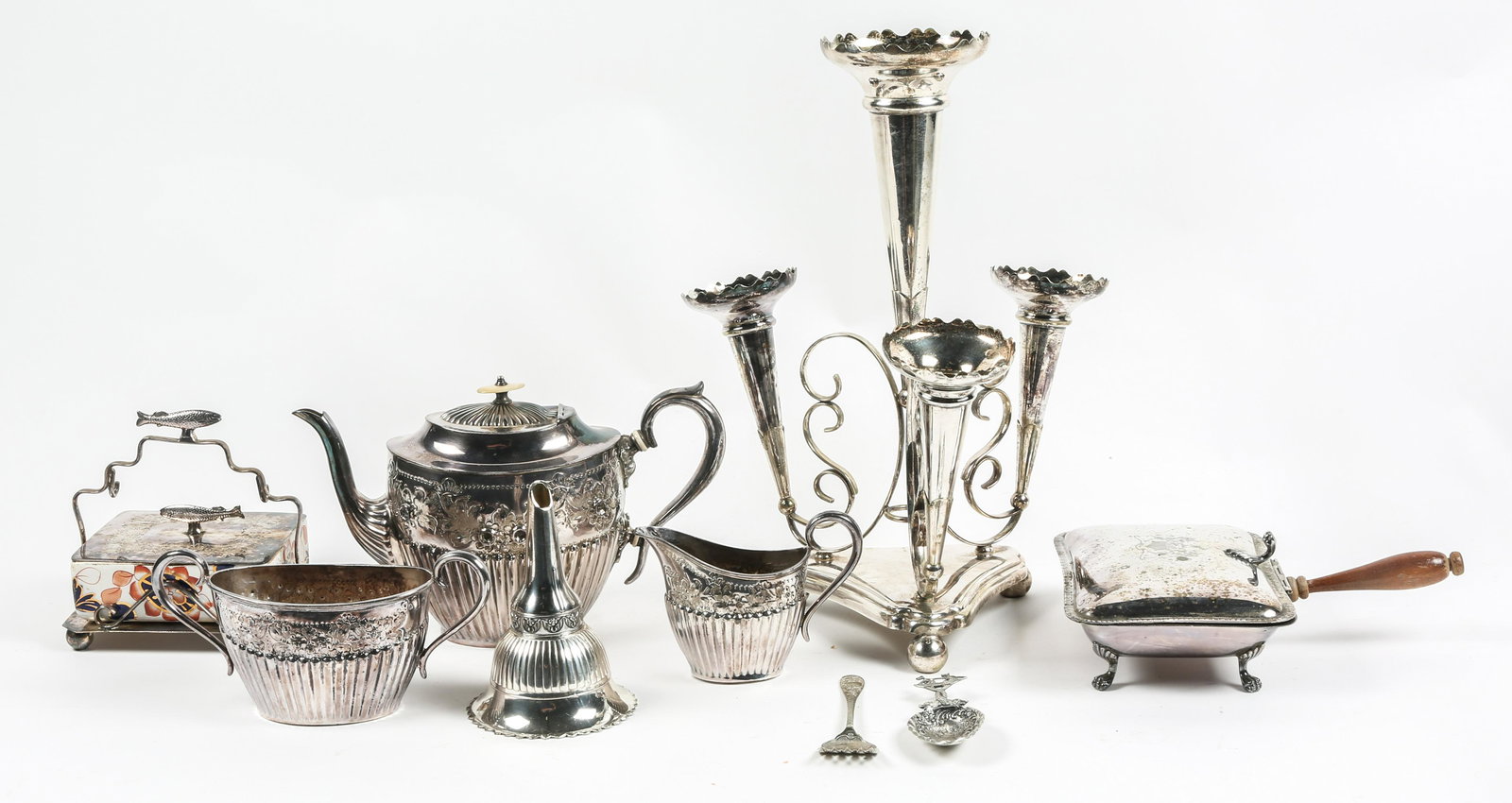 SILVERPLATE EPERGNE, SERVE WARE, & WINE SPOUT: SILVERPLATE EPERGNE, SERVE WARE, & WINE SPOUT Lot of 7 silver plated pieces. Includes serve ware, a wine spout, and an epergne. Sizes range from 2" tall to 14.50" tall. 
