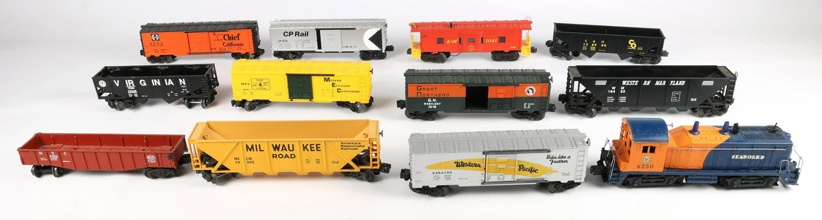 LIONEL O GAUGE MODEL TRAINS - LOT OF 12: LIONEL O GAUGE MODEL TRAINS - LOT OF 12 Lionel O gauge model trains - lot of 12, includes: Seaboard #6250 Locomotive, lock on the front of the shell is broken Milwaukee #19302 Hopper NYC #6462 Gond