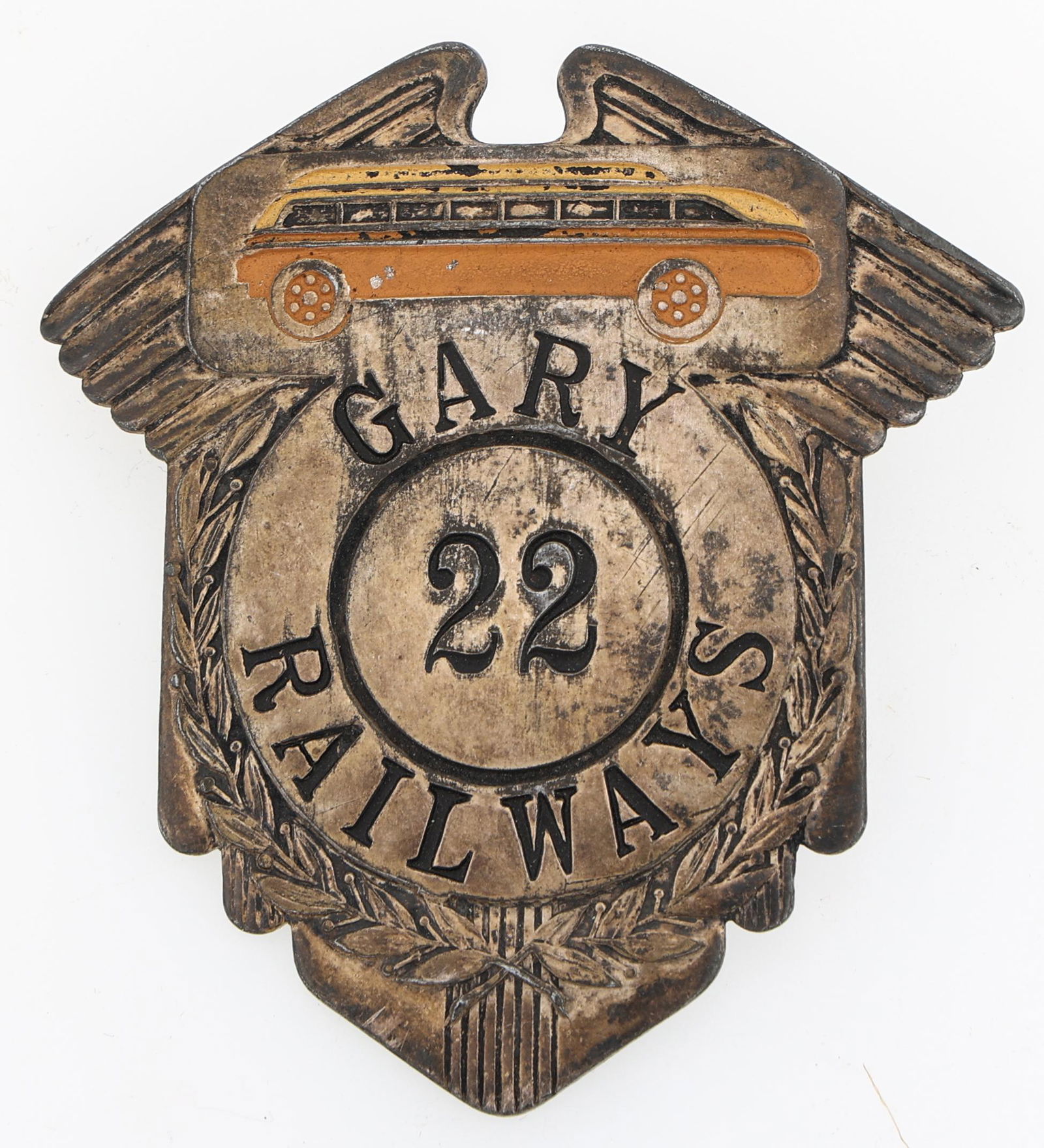 GARY RAILWAYS BADGE NO. 22: GARY RAILWAYS BADGE NO. 22 Obsolete Gary Railways badge. Number 22. Marked Fifth Avenue Uniform Company 19 SO. Wells Chicago on reverse. Measurements: 2 3/8 x 2 1/2"