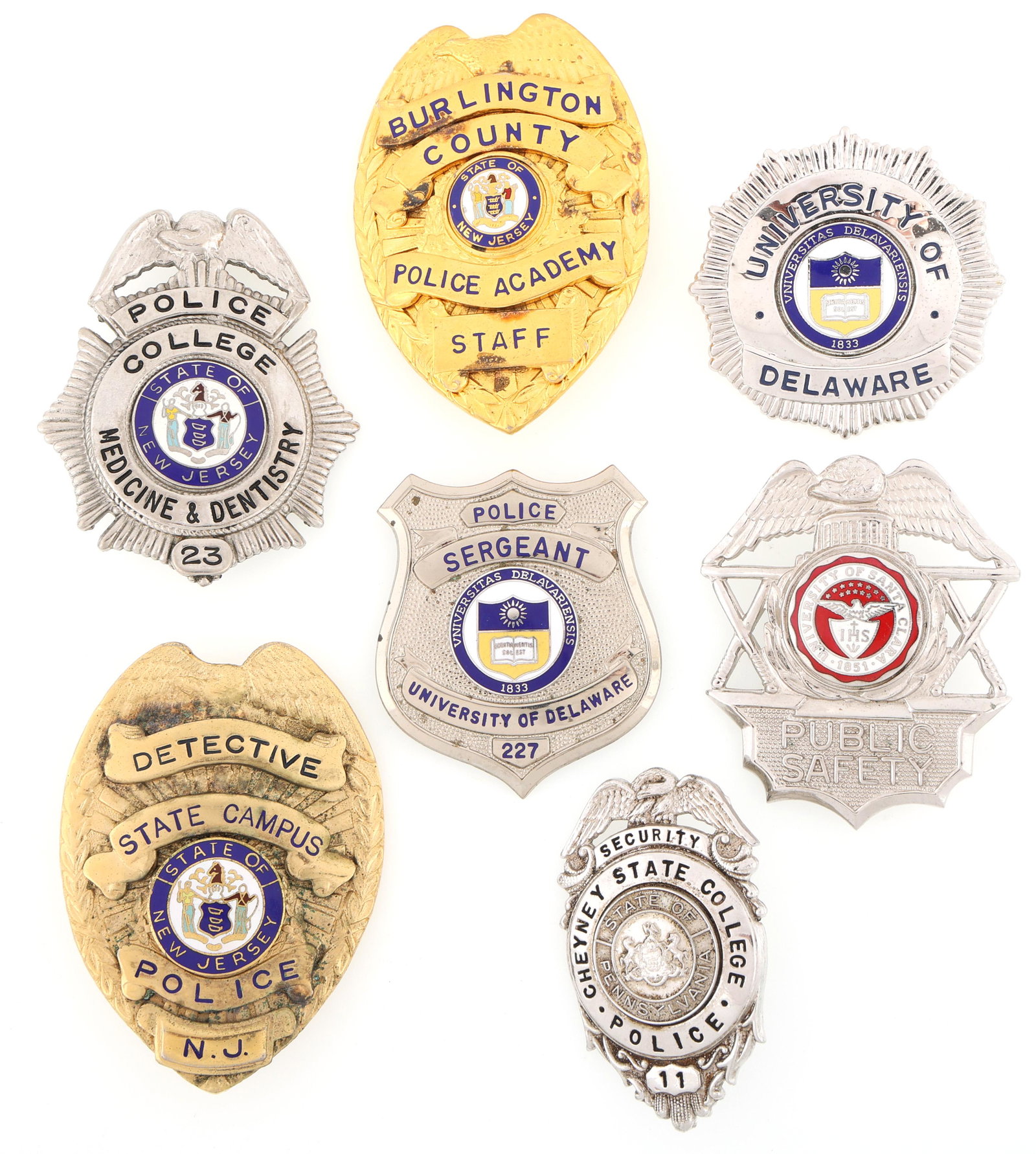 SCHOOL CAMPUS SECURITY BADGES - LOT OF SEVEN: SCHOOL CAMPUS SECURITY BADGES - LOT OF SEVEN Lot of seven School Campus Security badges, includes: University of Delaware Police Sergeant badge. Number 227. Marked Blackinton on reverse. Cal